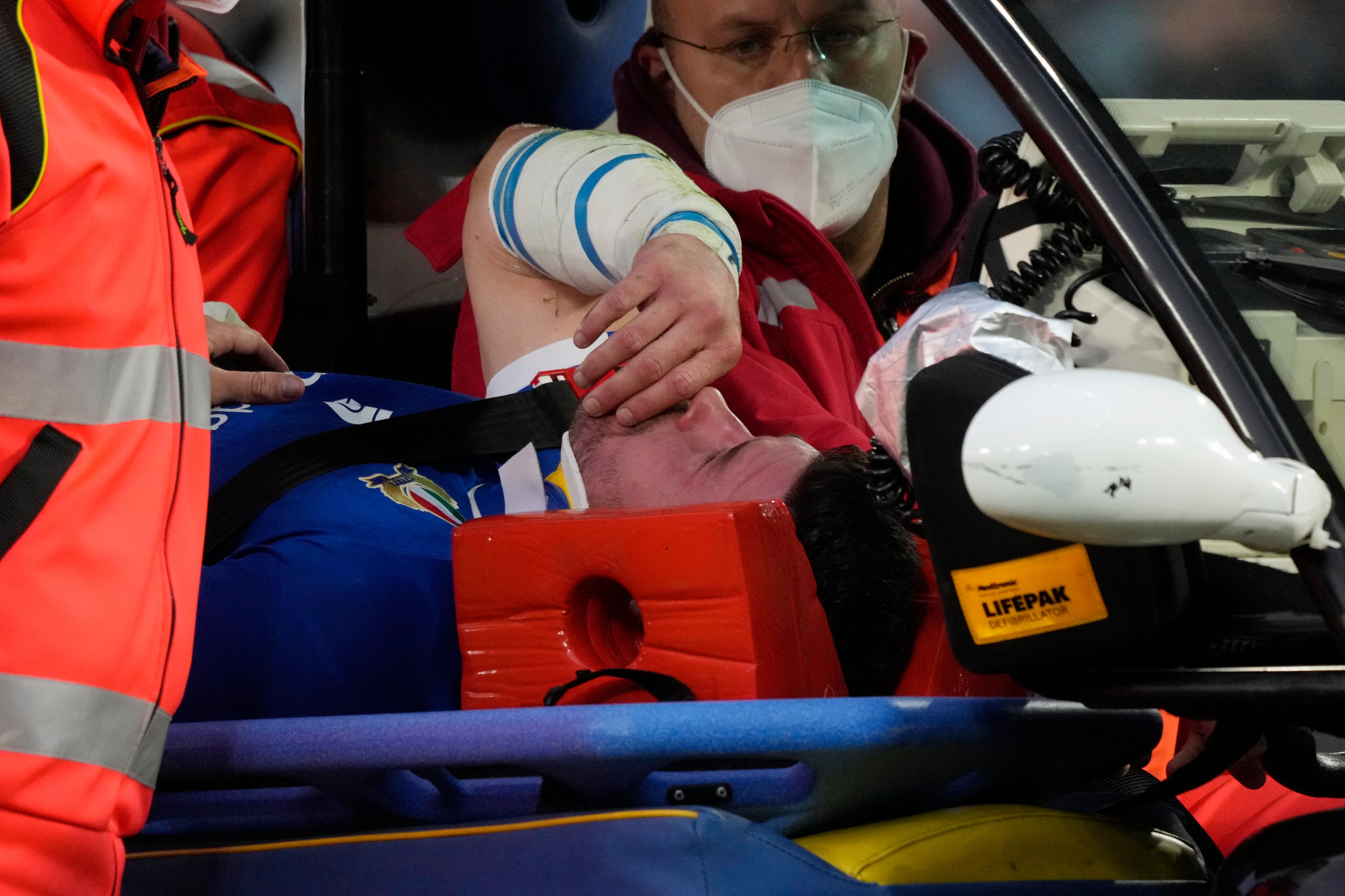 Italy’s Sebastian Negri is taken off the pitch (AP Photo/Gregorio Borgia)