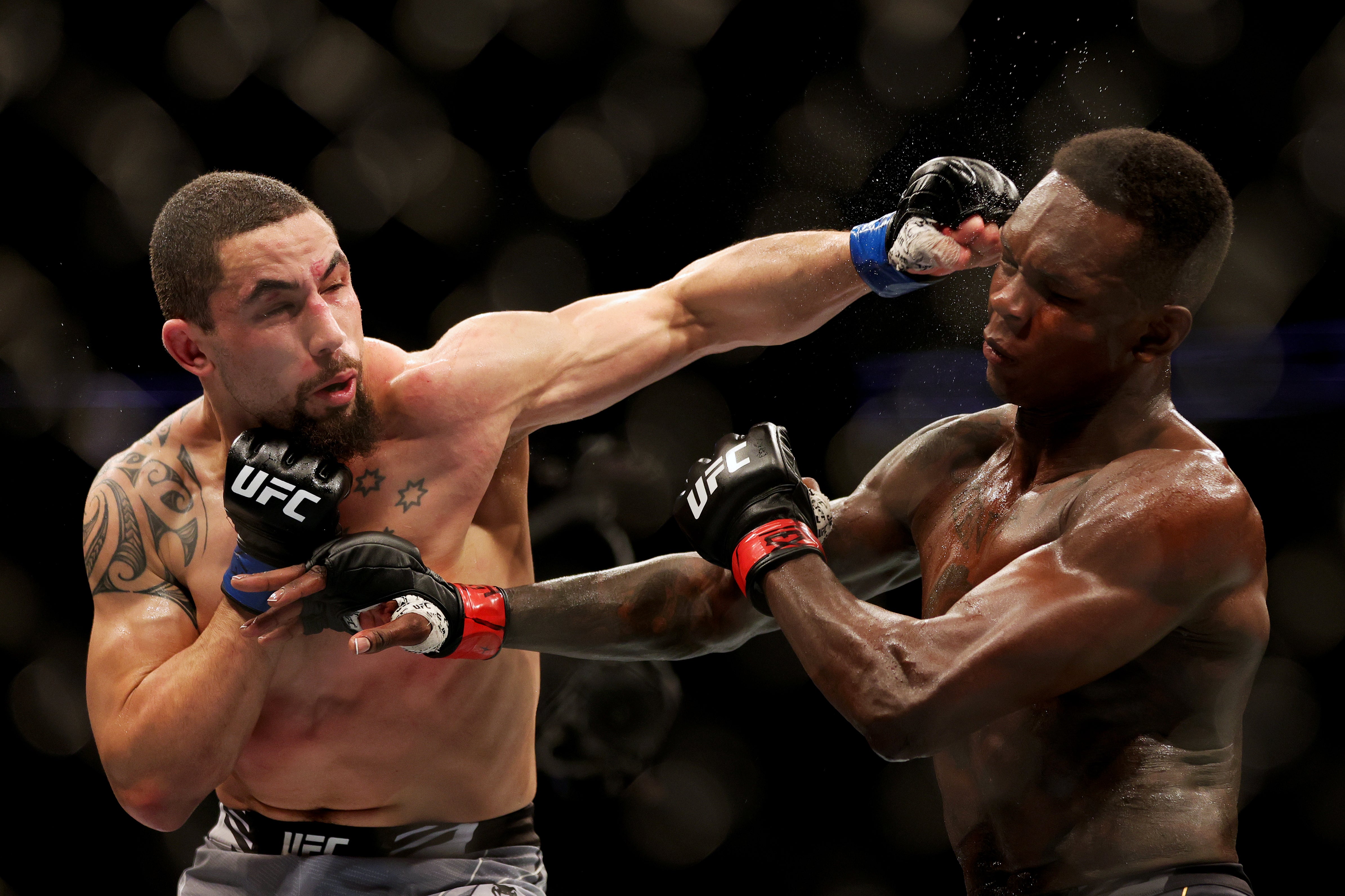 Robert Whittaker (left) only has two middleweight losses – both against Israel Adesanya