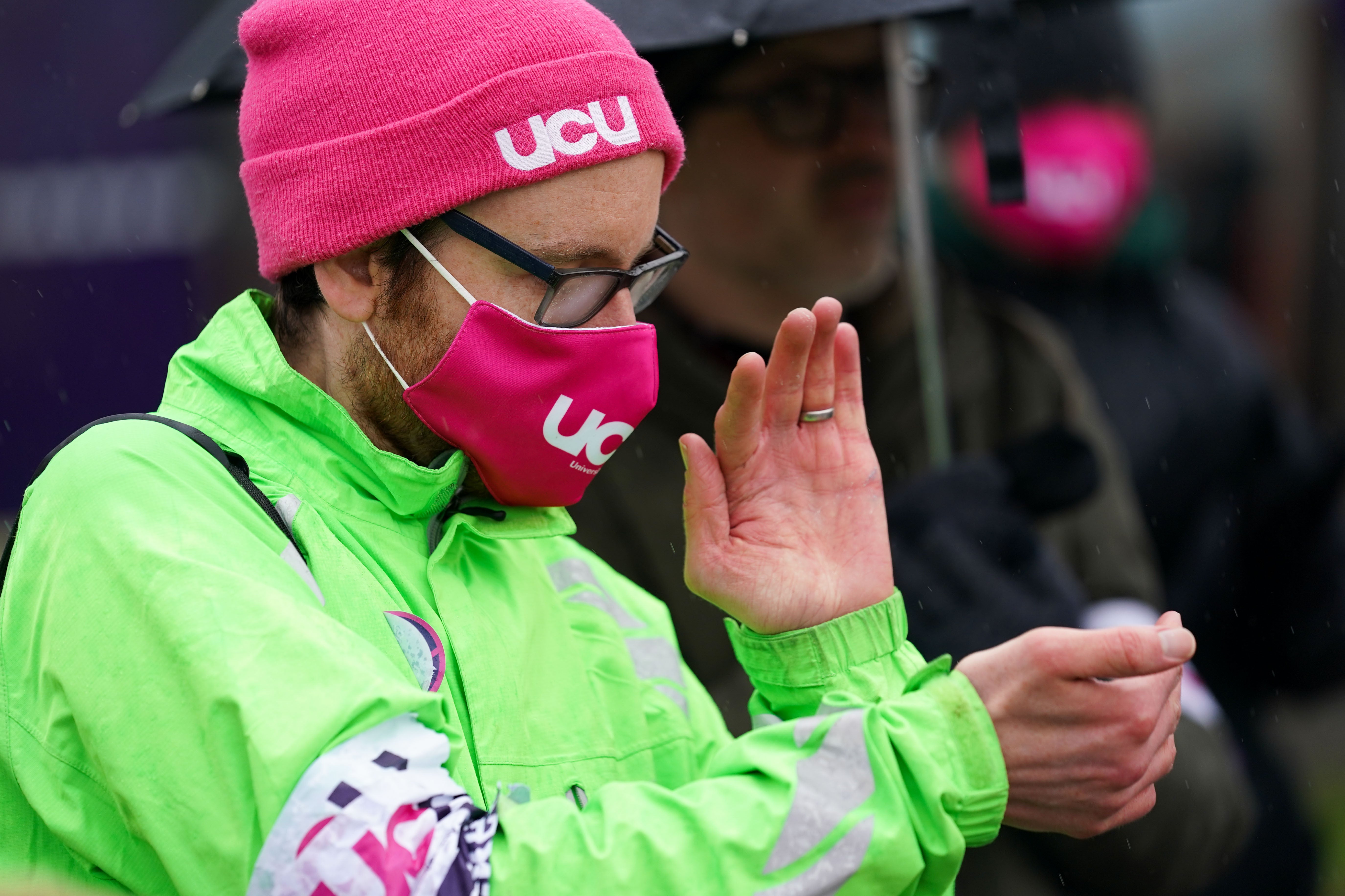 University of Birmingham staff and students join a picket line outside the campus as staff at 44 universities around the country begin strike action on Monday (PA)