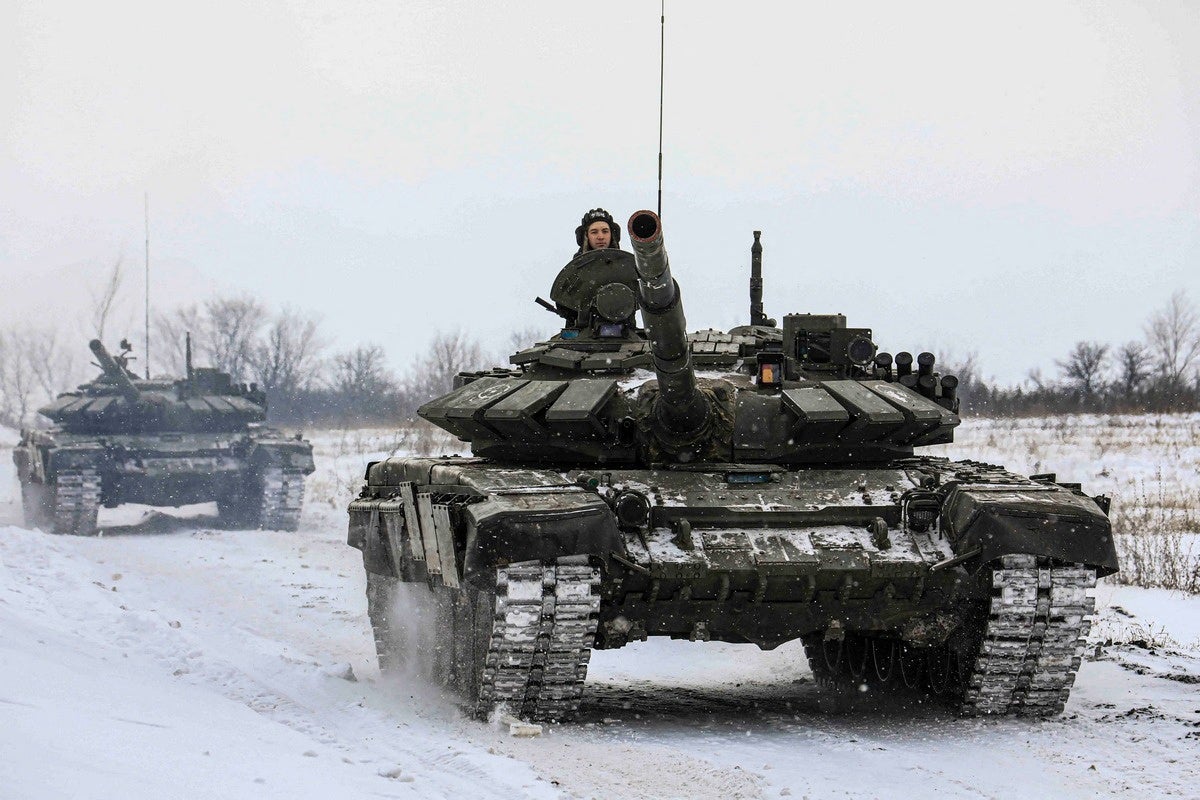 Russian servicemen drive tanks during military exercises in the Leningrad Region