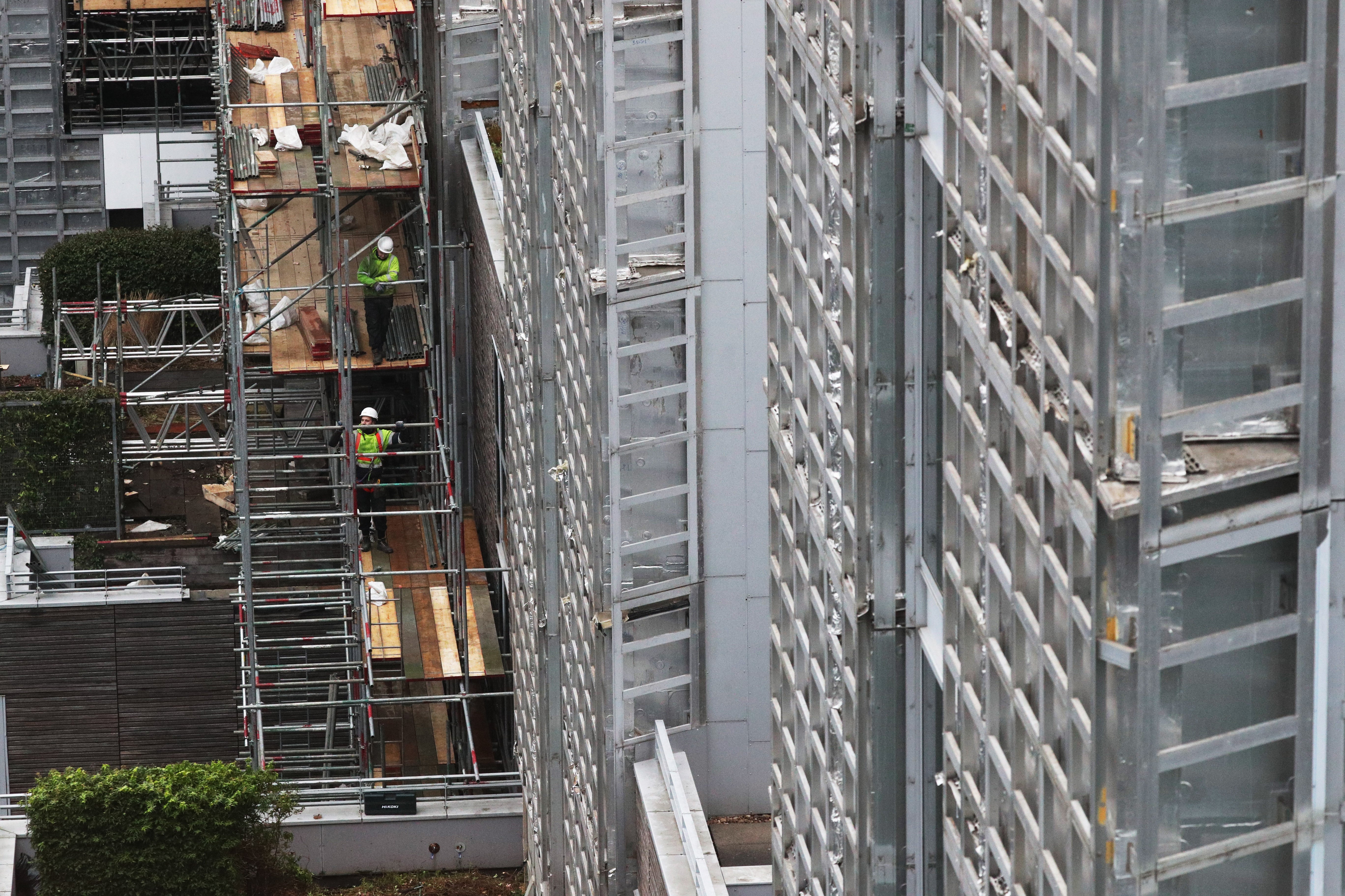 New laws could see developers and manufacturers effectively blocked from the housing market if they do not help fix cladding safety issues (PA)