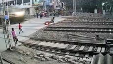 Man falls off bike on level crossing as high-speed train thunders past