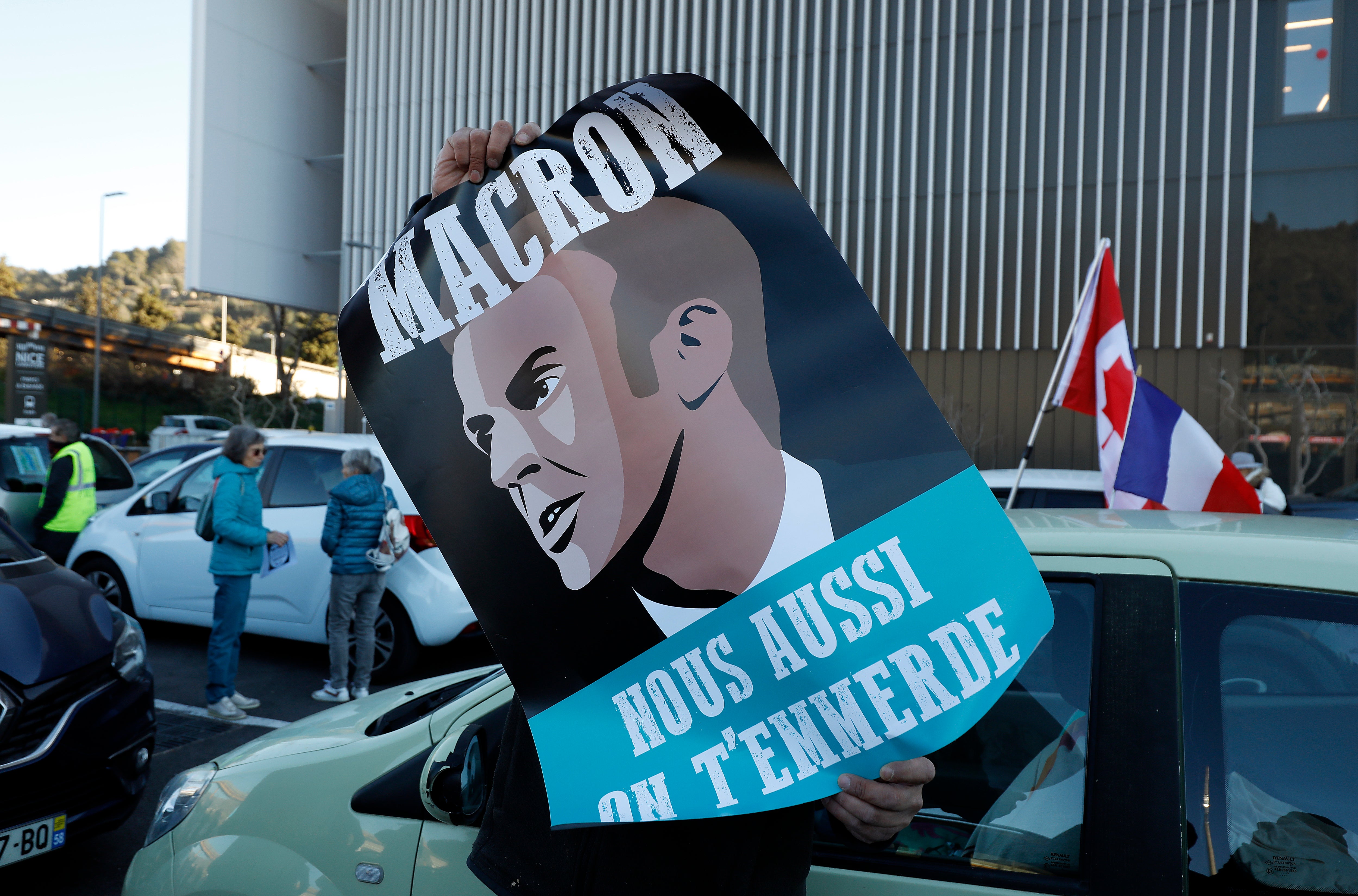 A placard reads ‘Macron, we’ll p*** you off too’ as members of the ‘Freedom Convoy 2022’ gather in Nice