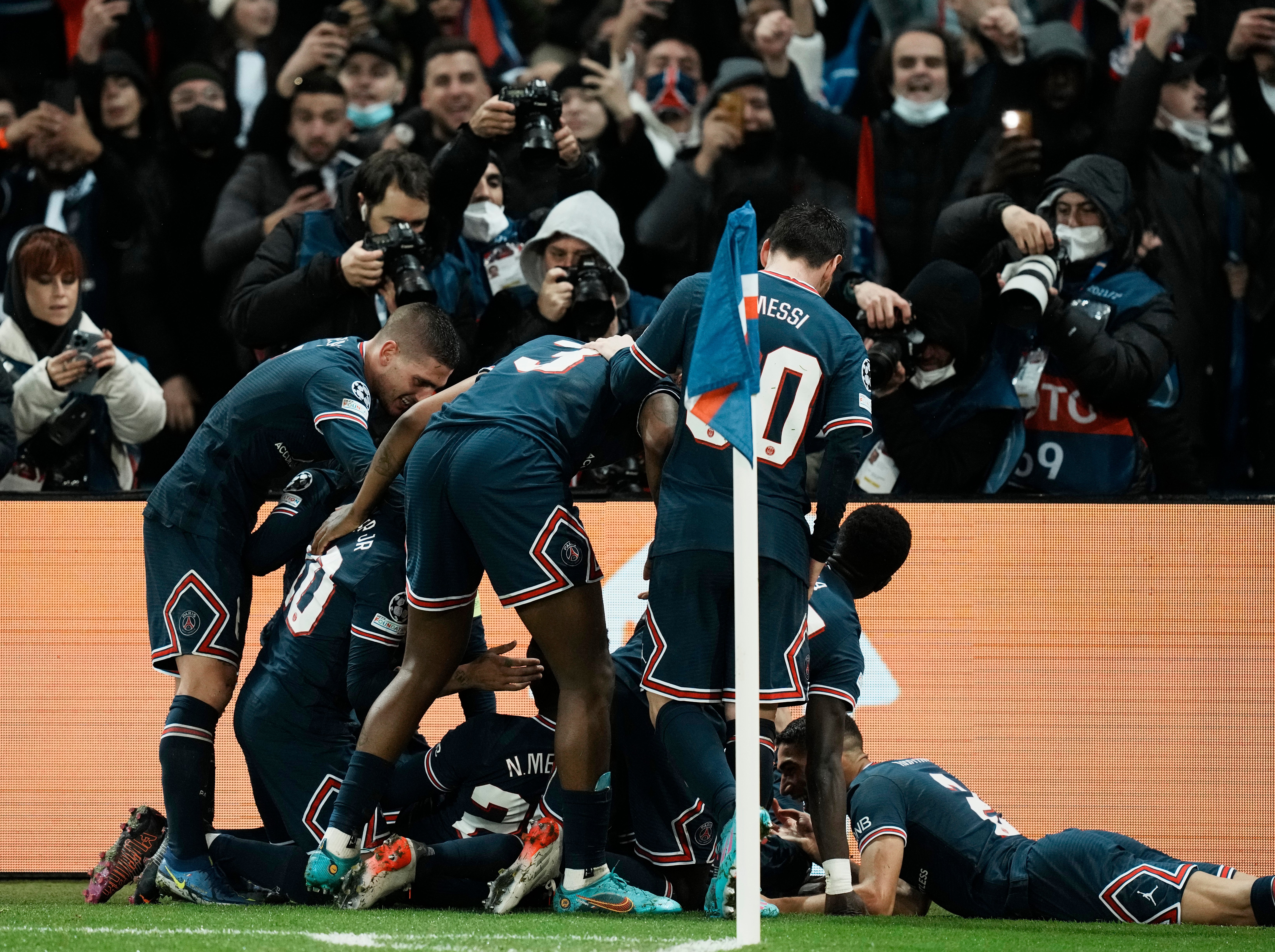 Mbappe is mobbed by his Paris St Germain teammates after his stoppage-time winner