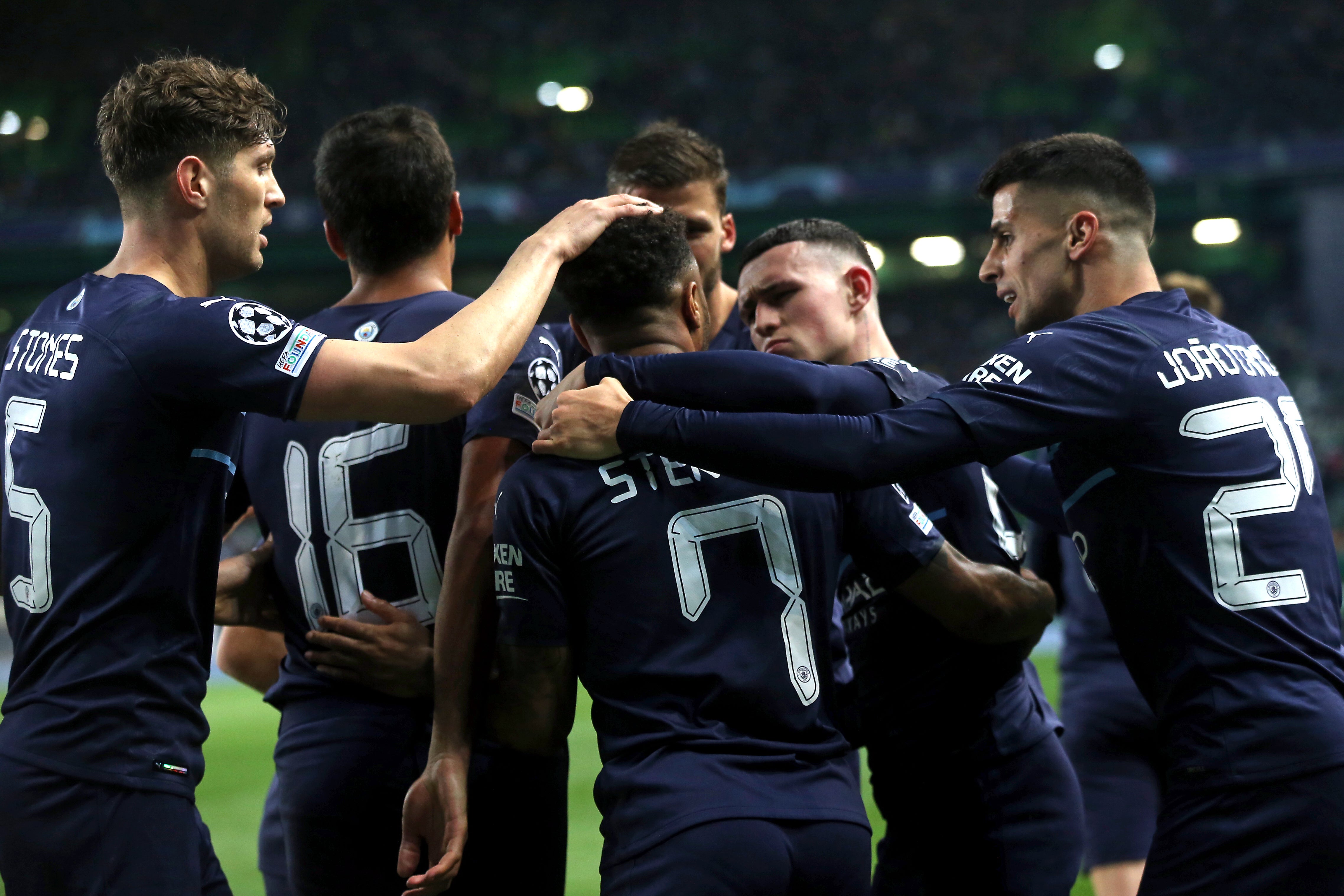 Raheem Sterling, centre, and City celebrate their fifth goal (Isabel Infantes/PA)