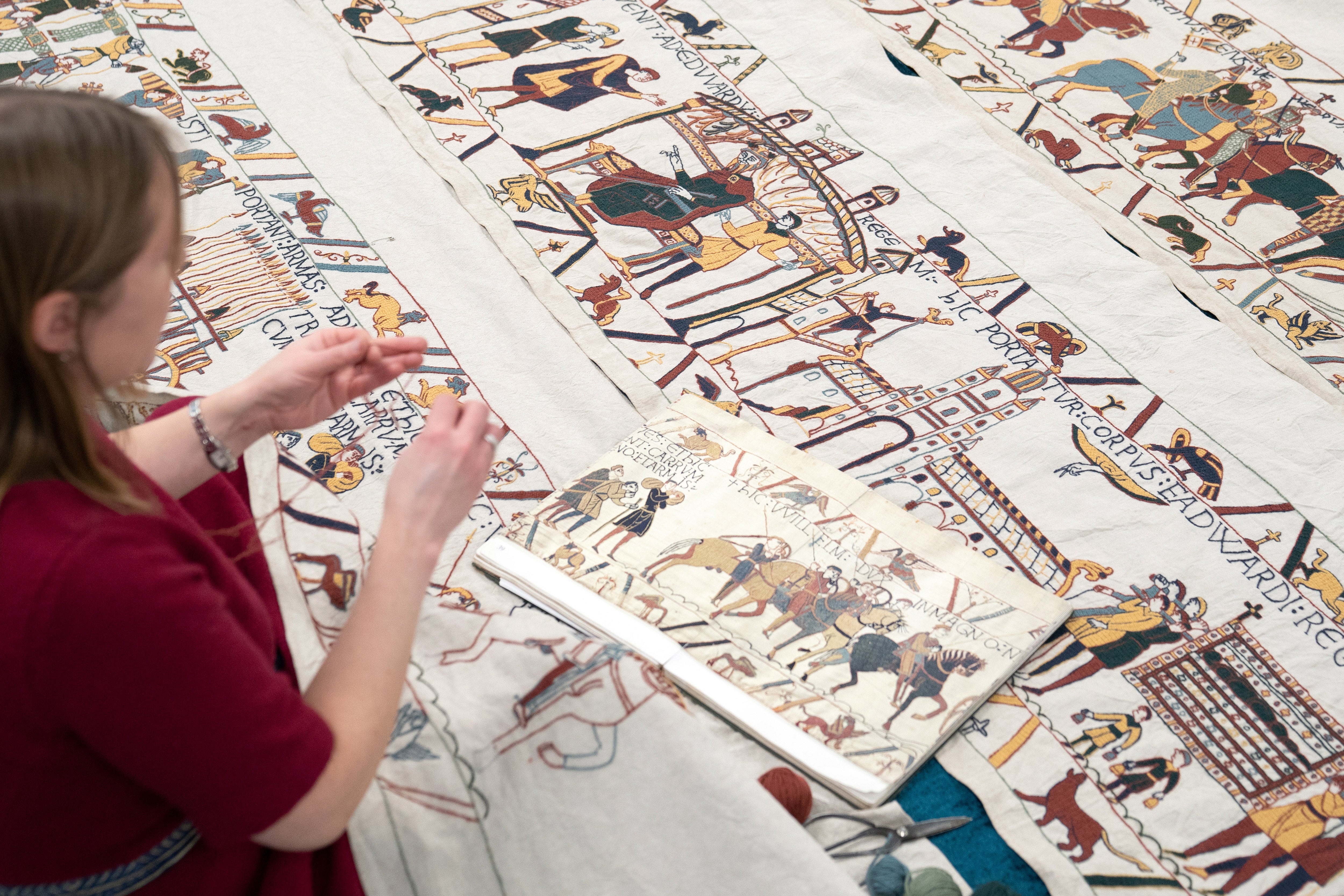 Mia Hansson, 47, of Wisbech, Cambridgeshire, with some of her full-size replica of the Bayeux Tapestry, which she is more than halfway through making. (Joe Giddens/ PA)