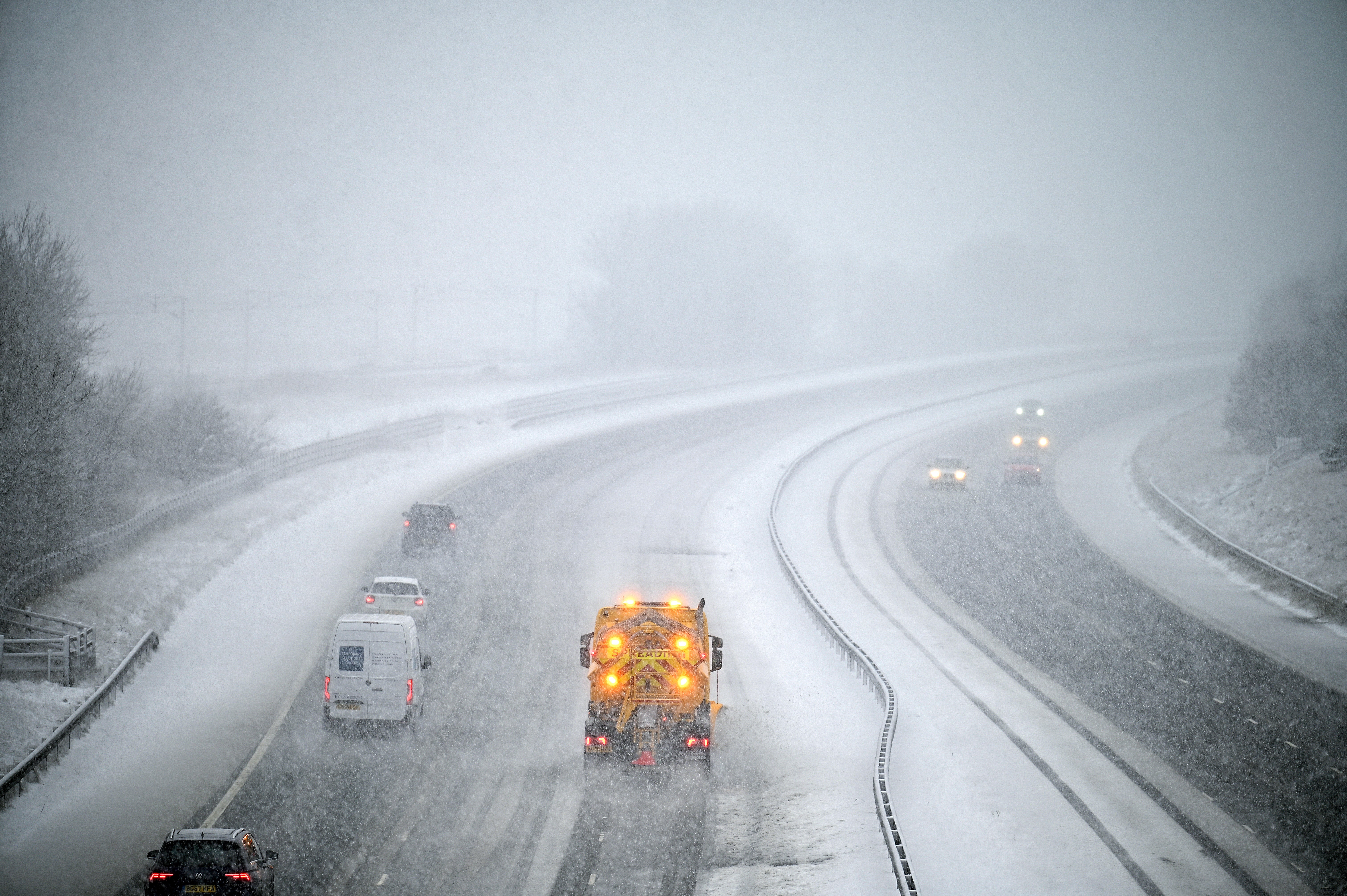 Vehicles make their way along the M74 between Abiington and Beattock Summit in the snow