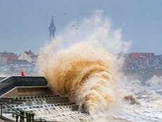 UK weather - latest updates: Storm Eunice claims first victim as 100,000 lose power and hole torn in O2 roof