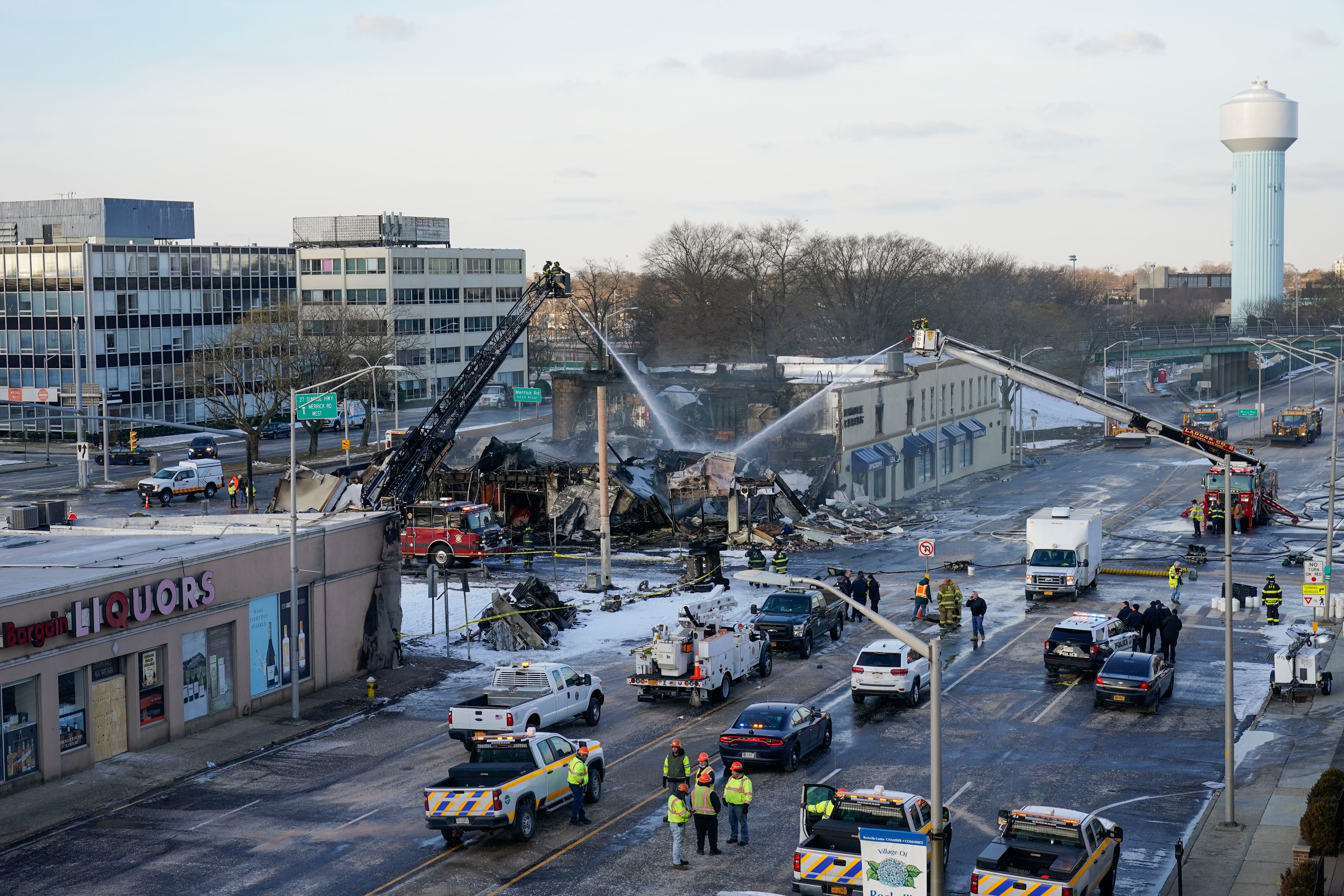 Emergency personnel work at the site of gas tanker accident in Rockville Centre, N.Y., early Wednesday, Feb. 16, 2022