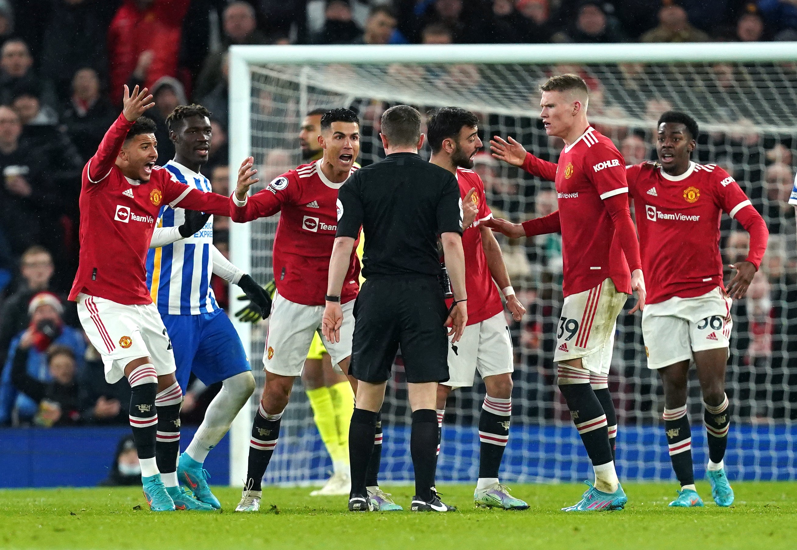 Manchester United players fume at referee Peter Bankes (Martin Rickett/PA)