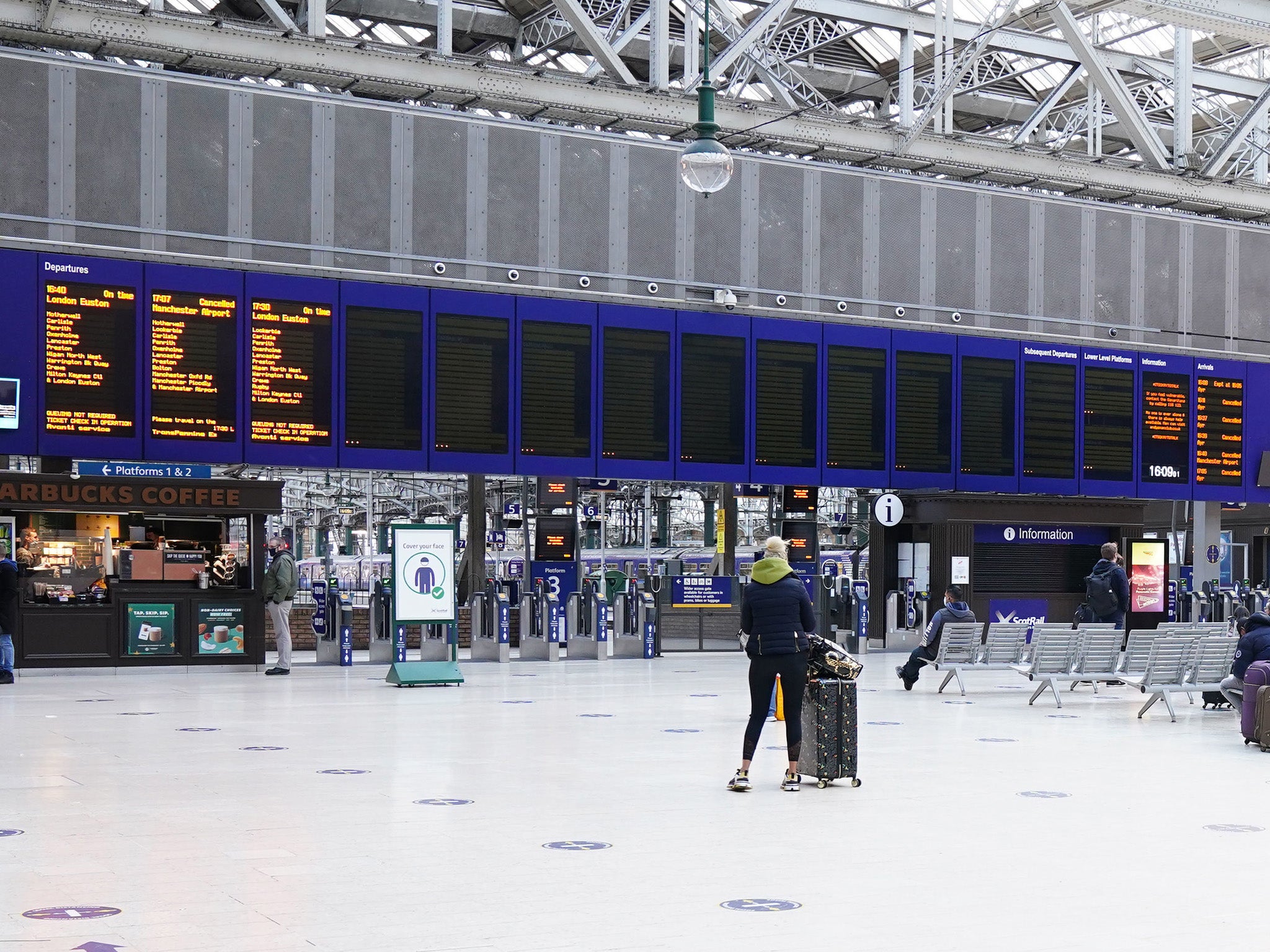 An almost empty departure board at Glasgow Central Station after trains and ferry services stopped running