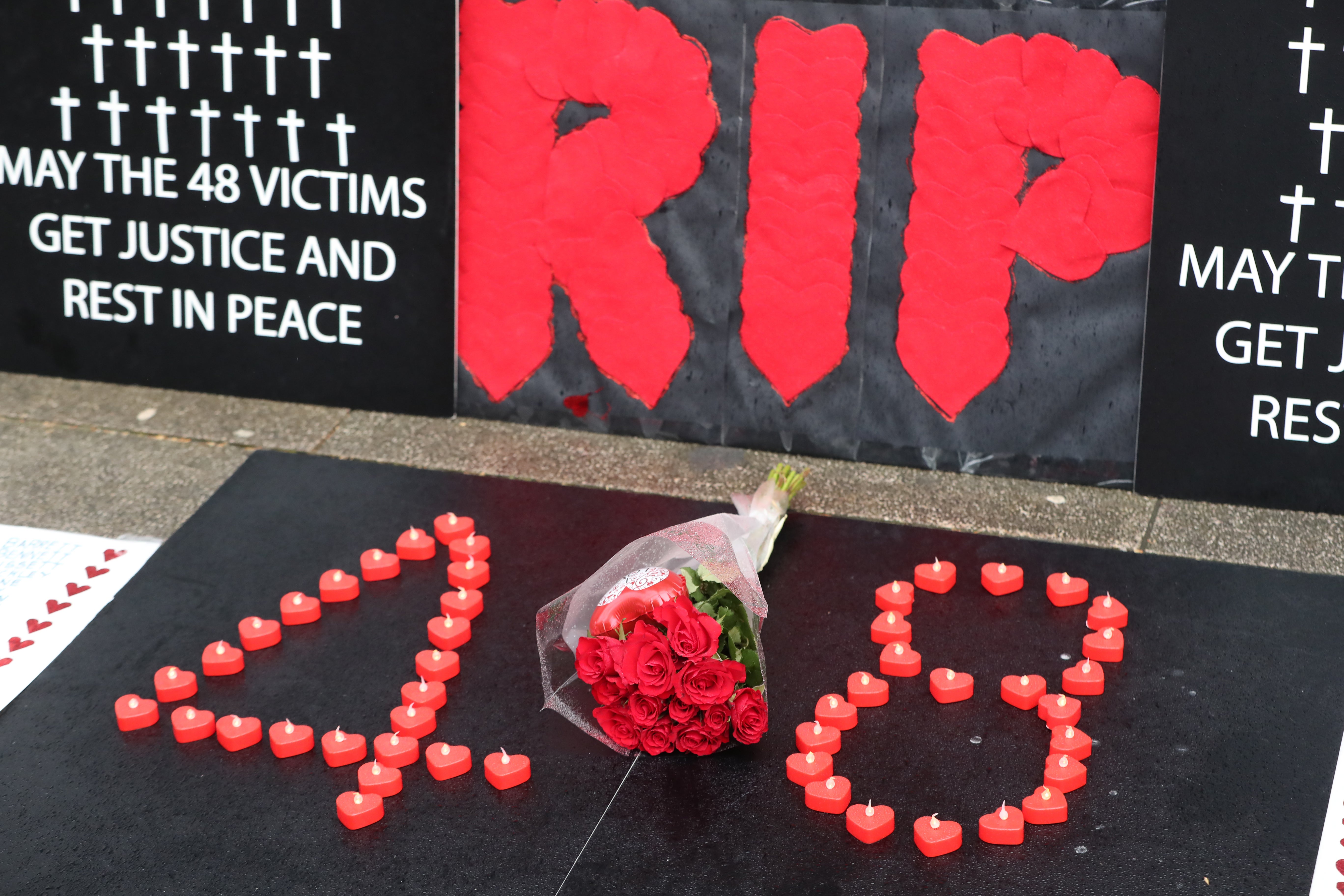 Candles and flowers placed outside Leinster House in Dublin by relatives of the 48 victims of the Stardust nightclub fire (Niall Carson/PA)