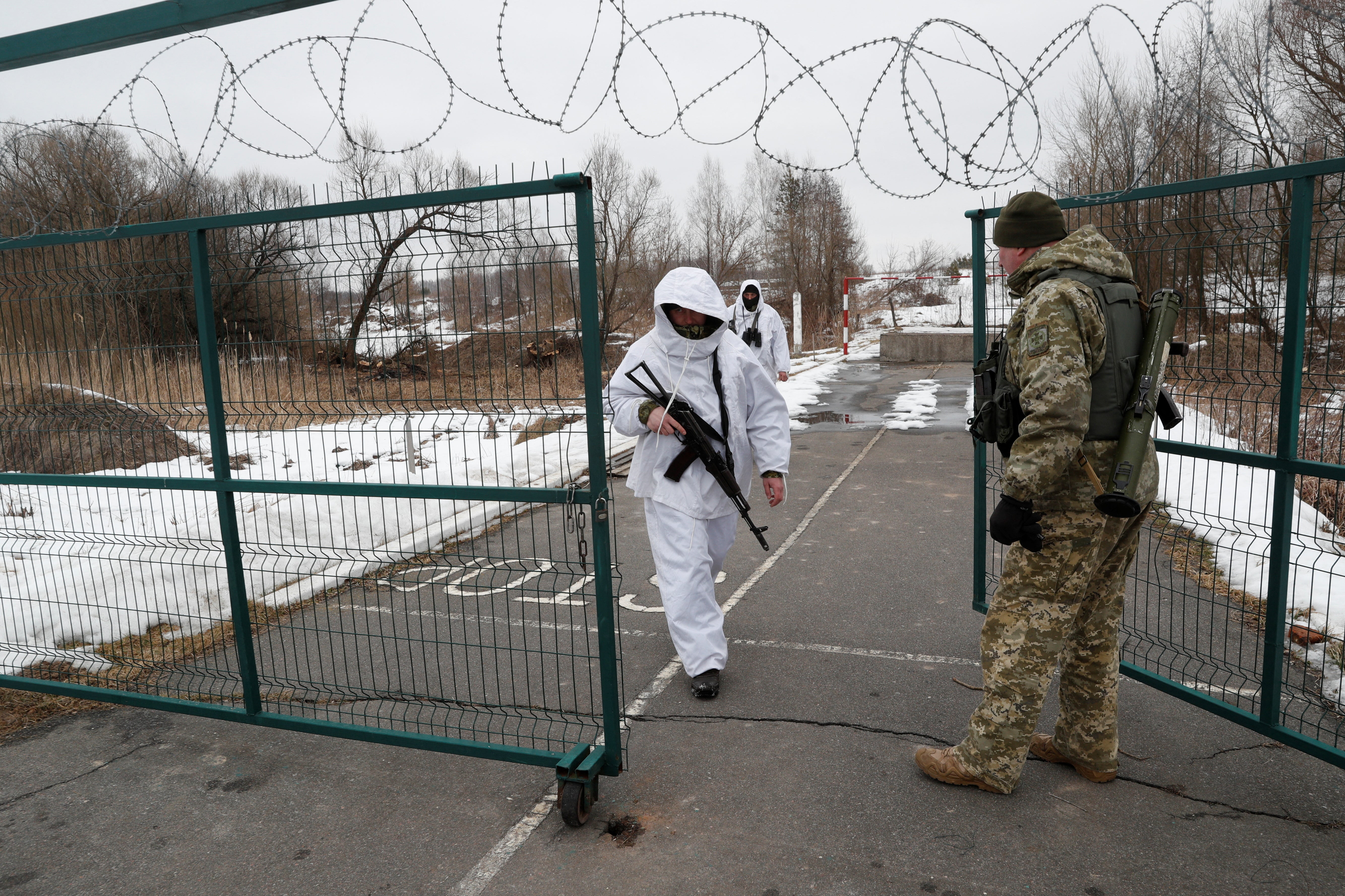 Members of the Ukrainian State Border Guard Service keep watch at the Kliusy checkpoint near the frontier with Russia in the Chernihiv region