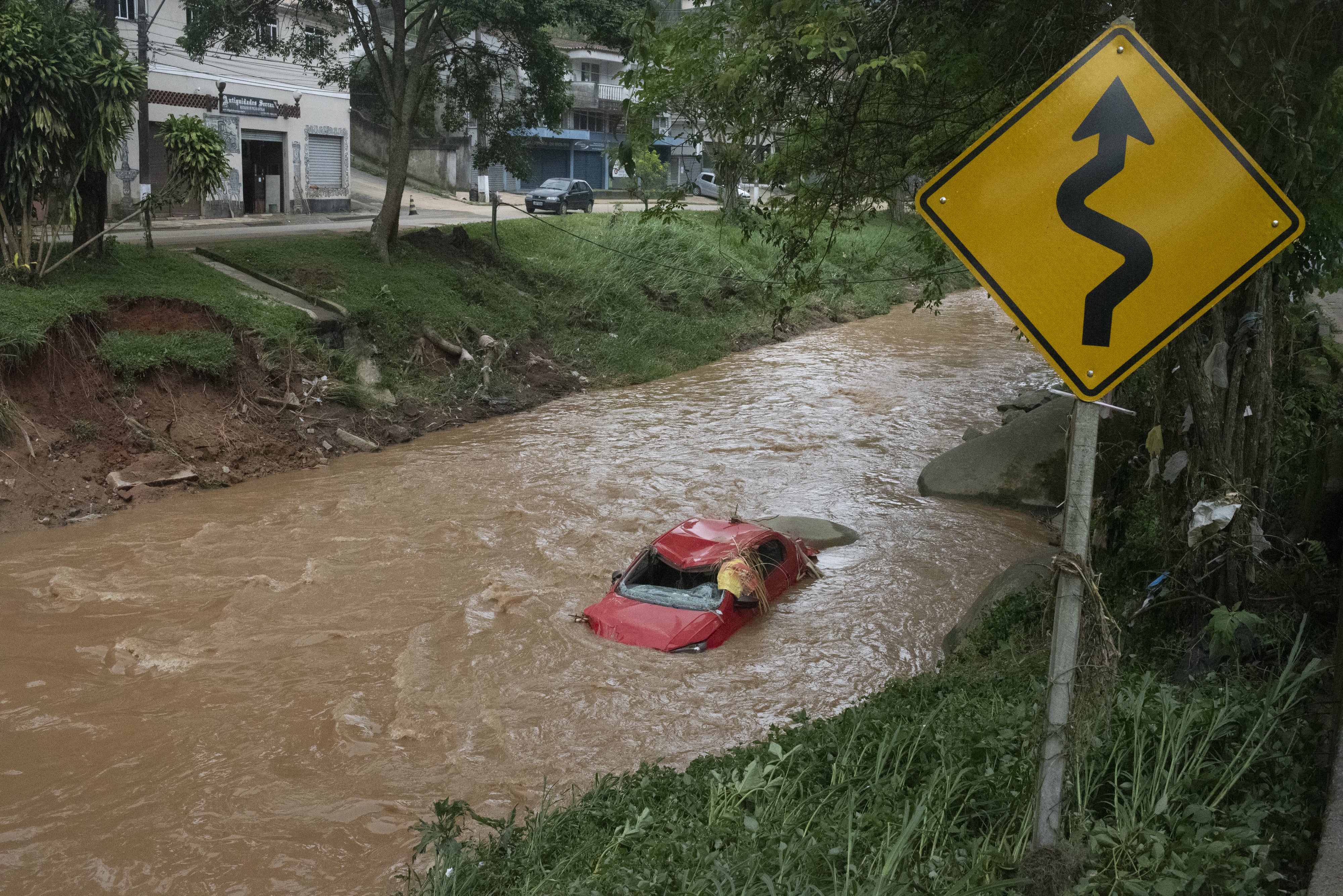 A vehicle is seen in a stream after heavy rains hit Petropolis