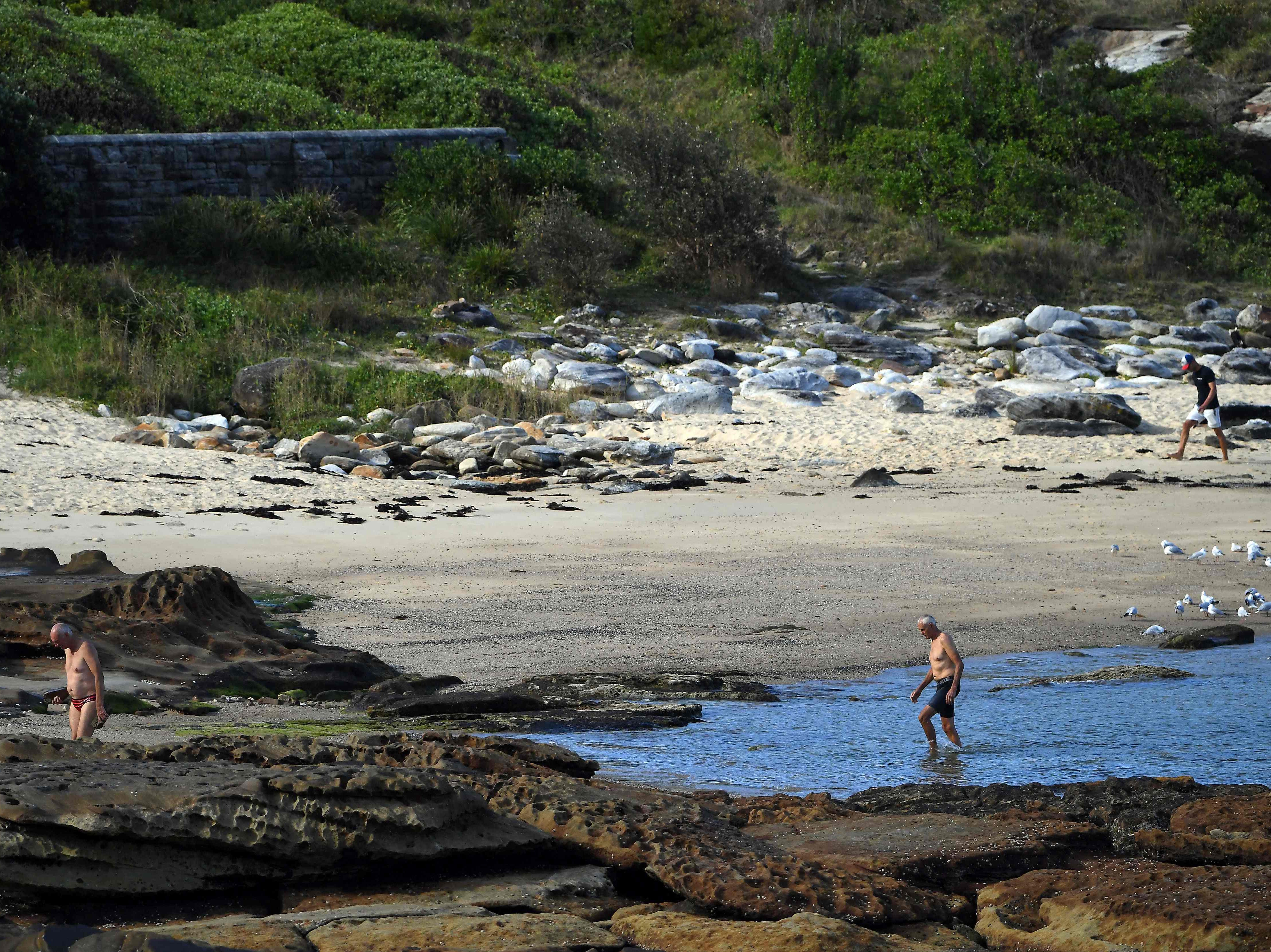 People walk close to the site of the fatal shark attack off Little Bay Beach in Sydney