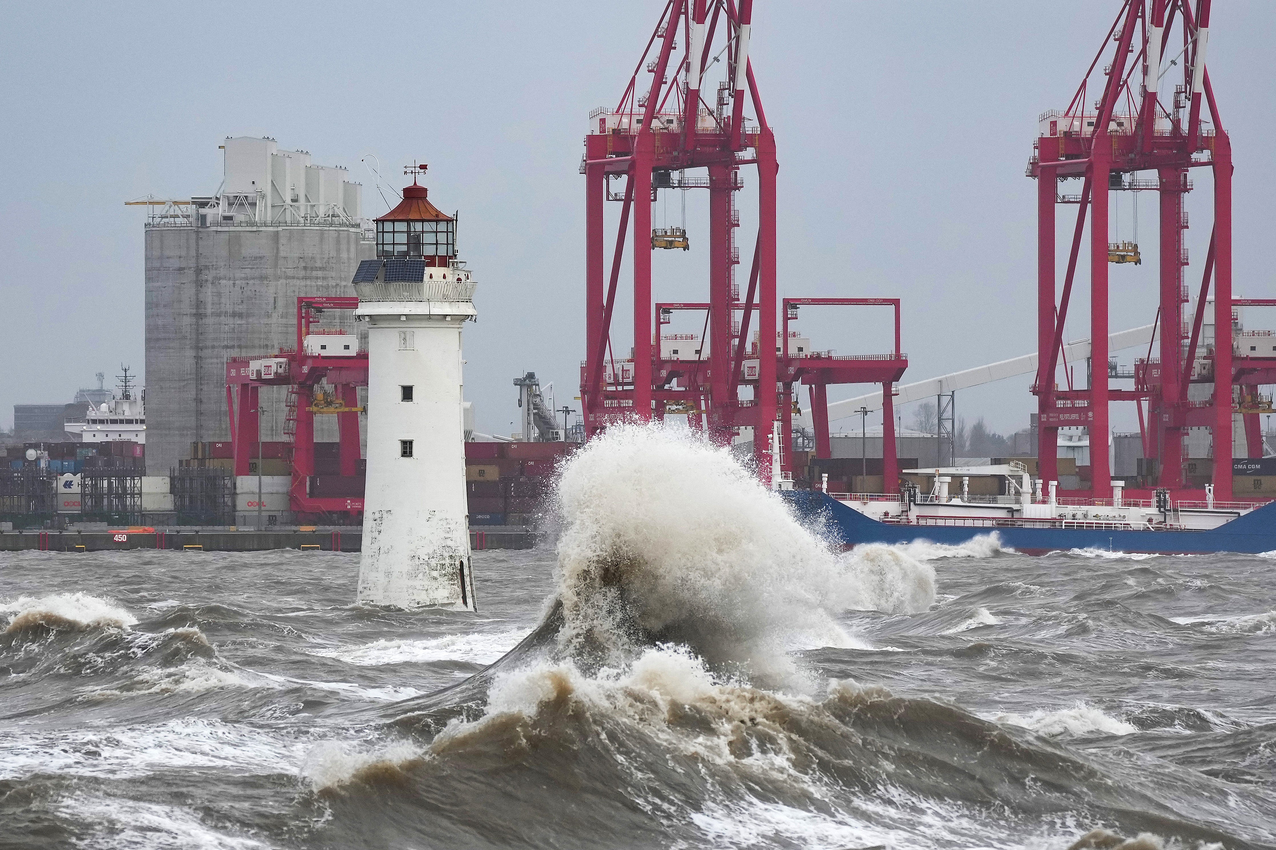 Waves created by high winds and Spring tides hit the sea wall at New Brighton promenade on February 17, 2022 in Liverpool