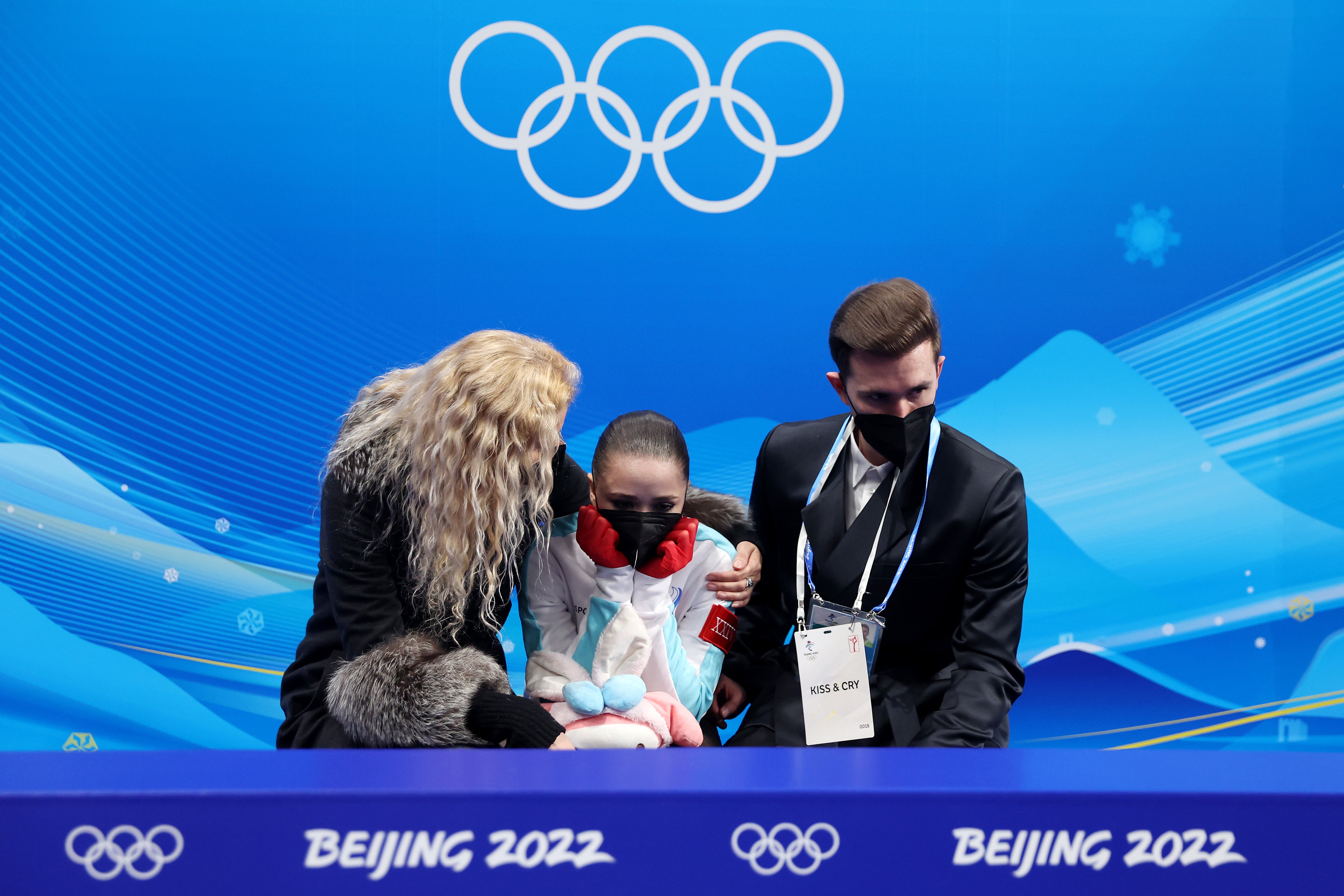 Kamila Valieva of Team ROC reacts to their score with choreographer Daniil Gleikhengauz (R) and coach Eteri Tutberidze (L) after the Women Single Skating Free Skating on day thirteen