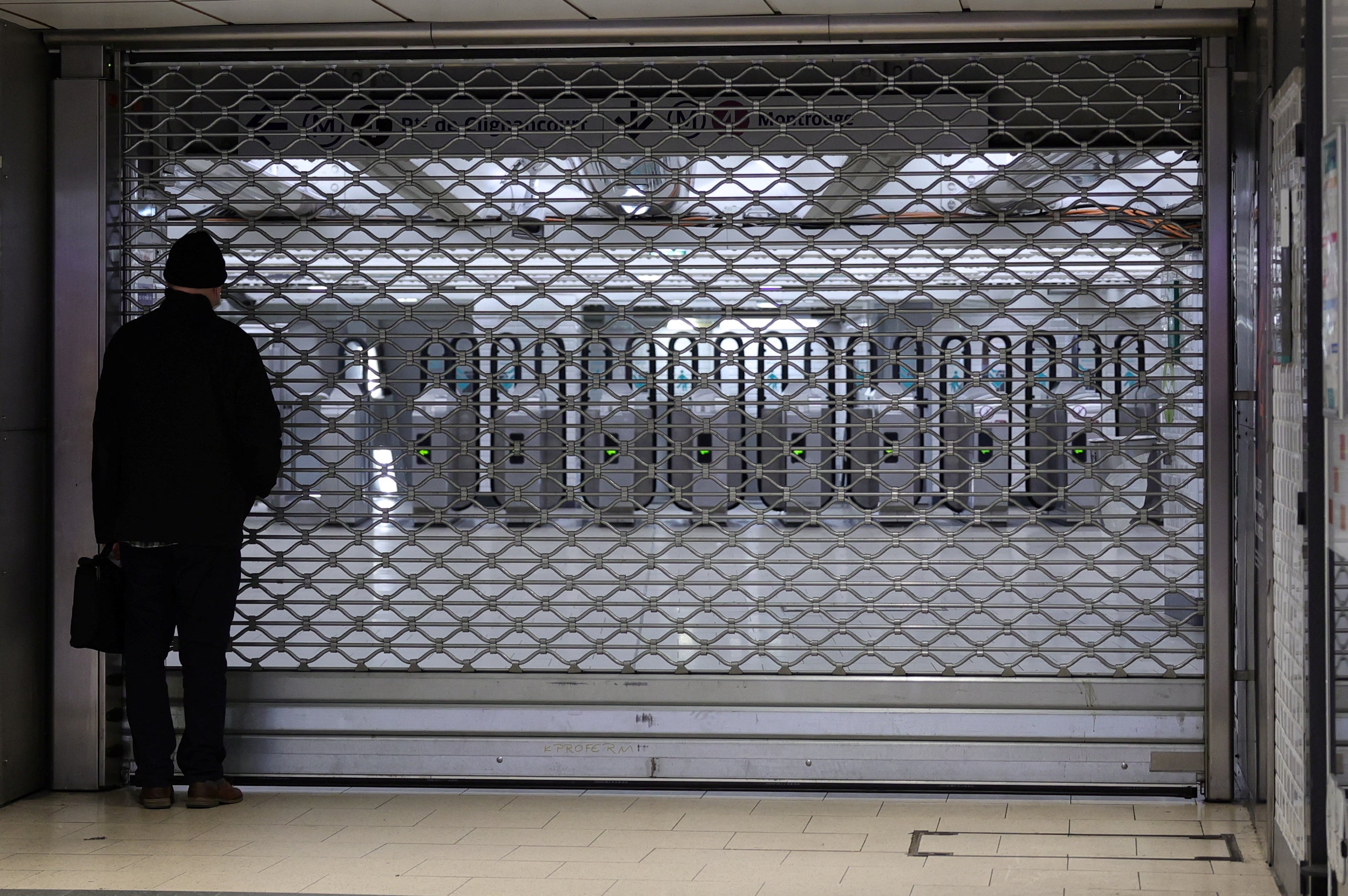 A man looks at a closed entrance at the Gare du Nord metro station in Paris, France, 18 February 2022