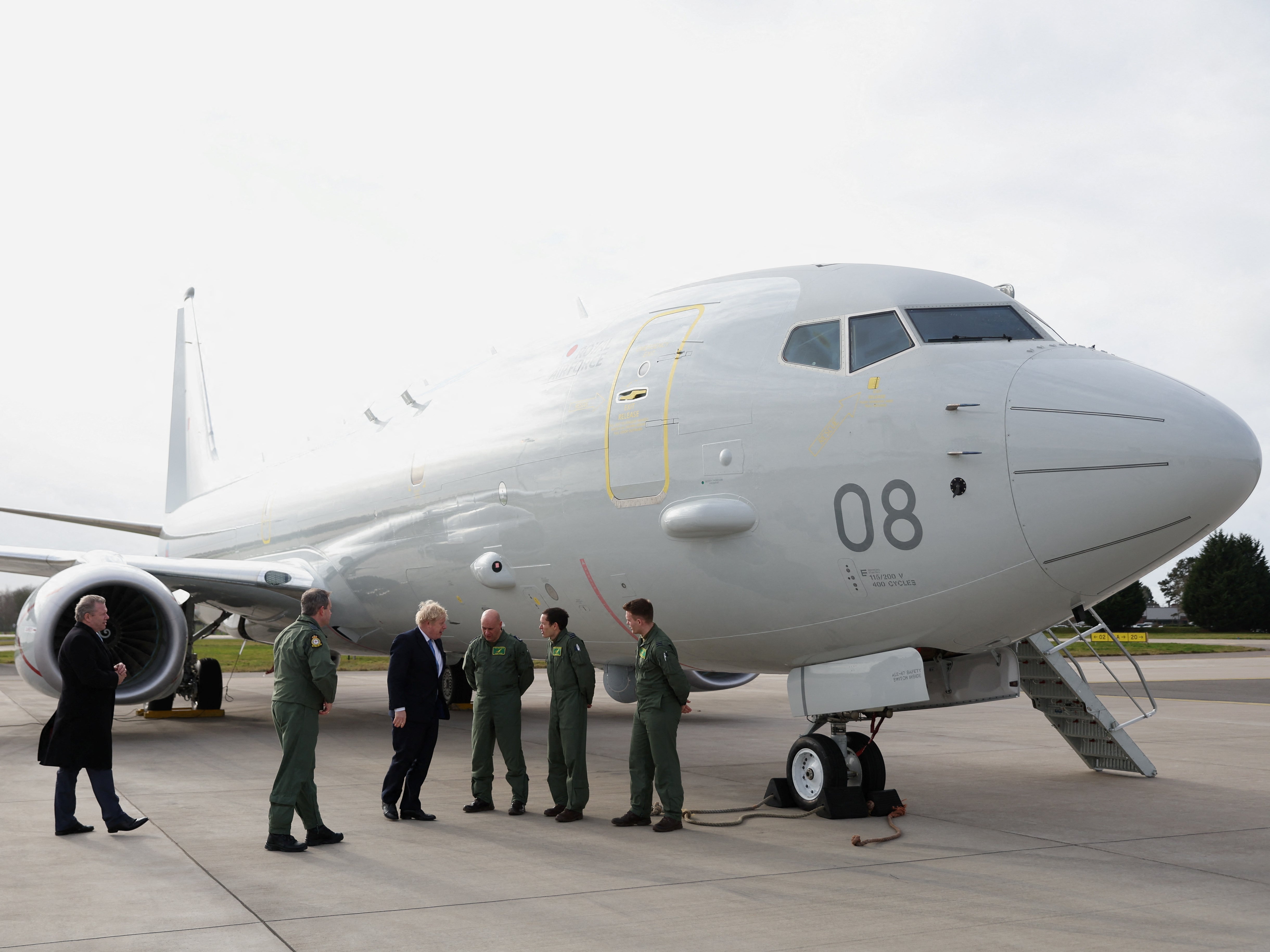 Boris Johnson next to RAF P-8A Poseidon plane at RAF Waddington base