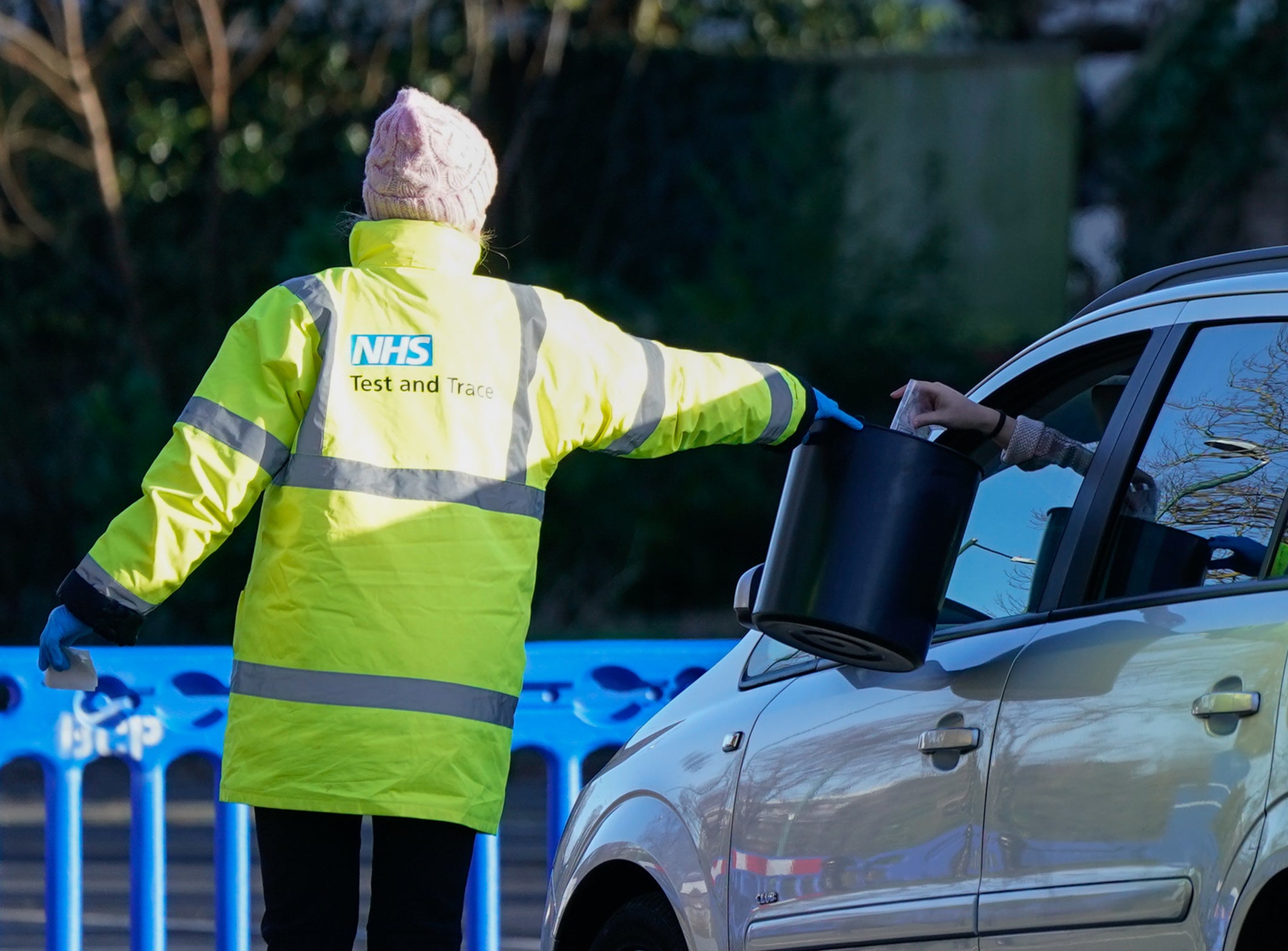 A member of NHS Test and Trace collects a sample from a member of the public at a testing site in Bournemouth (Andrew Matthews/PA)