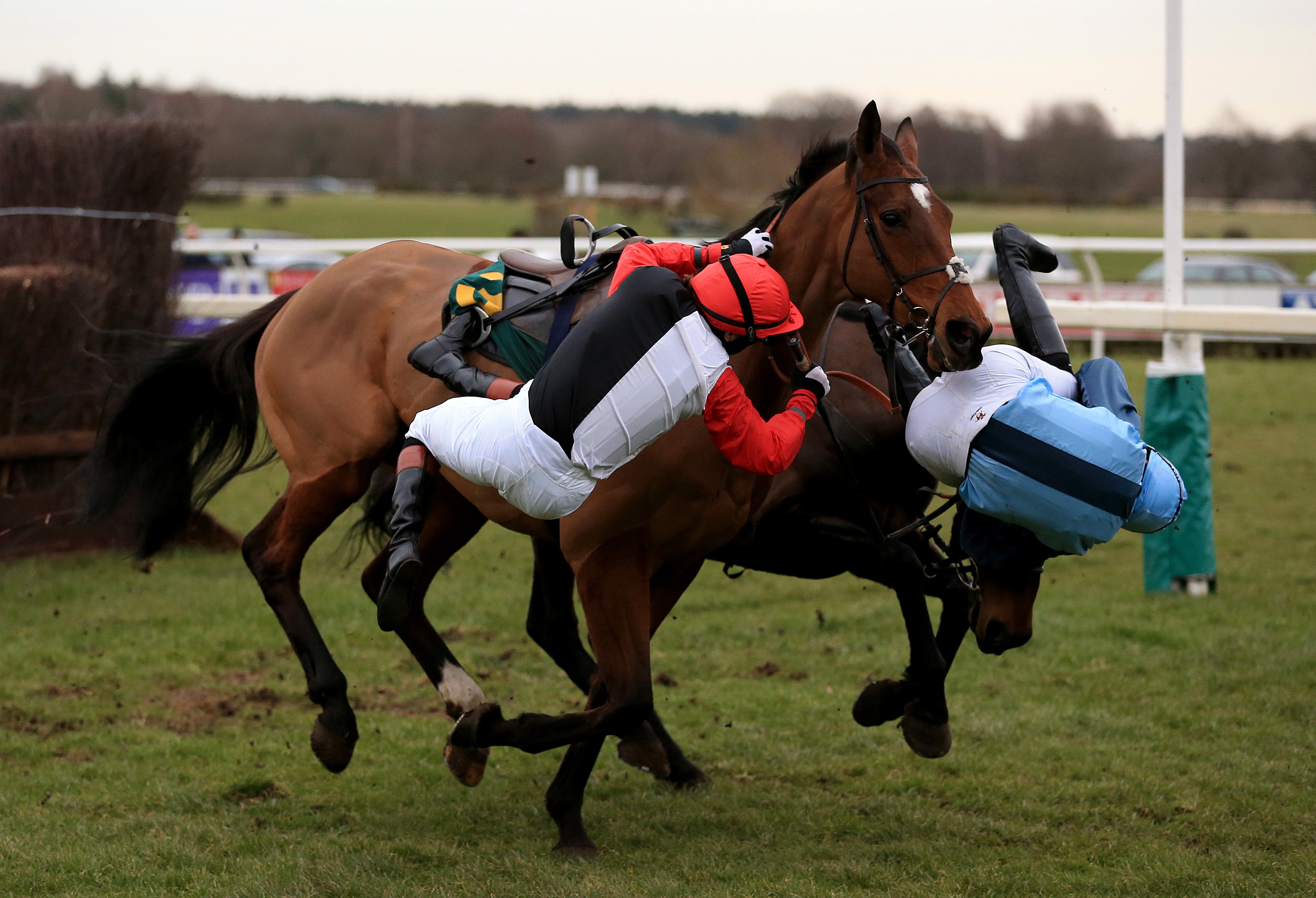 Pendleton, left, falls off Pacha Du Polder during the Betfair Switching Saddles ‘Grassroots’ Fox Hunters’ Chase at Fakenham (Nigel French/PA)