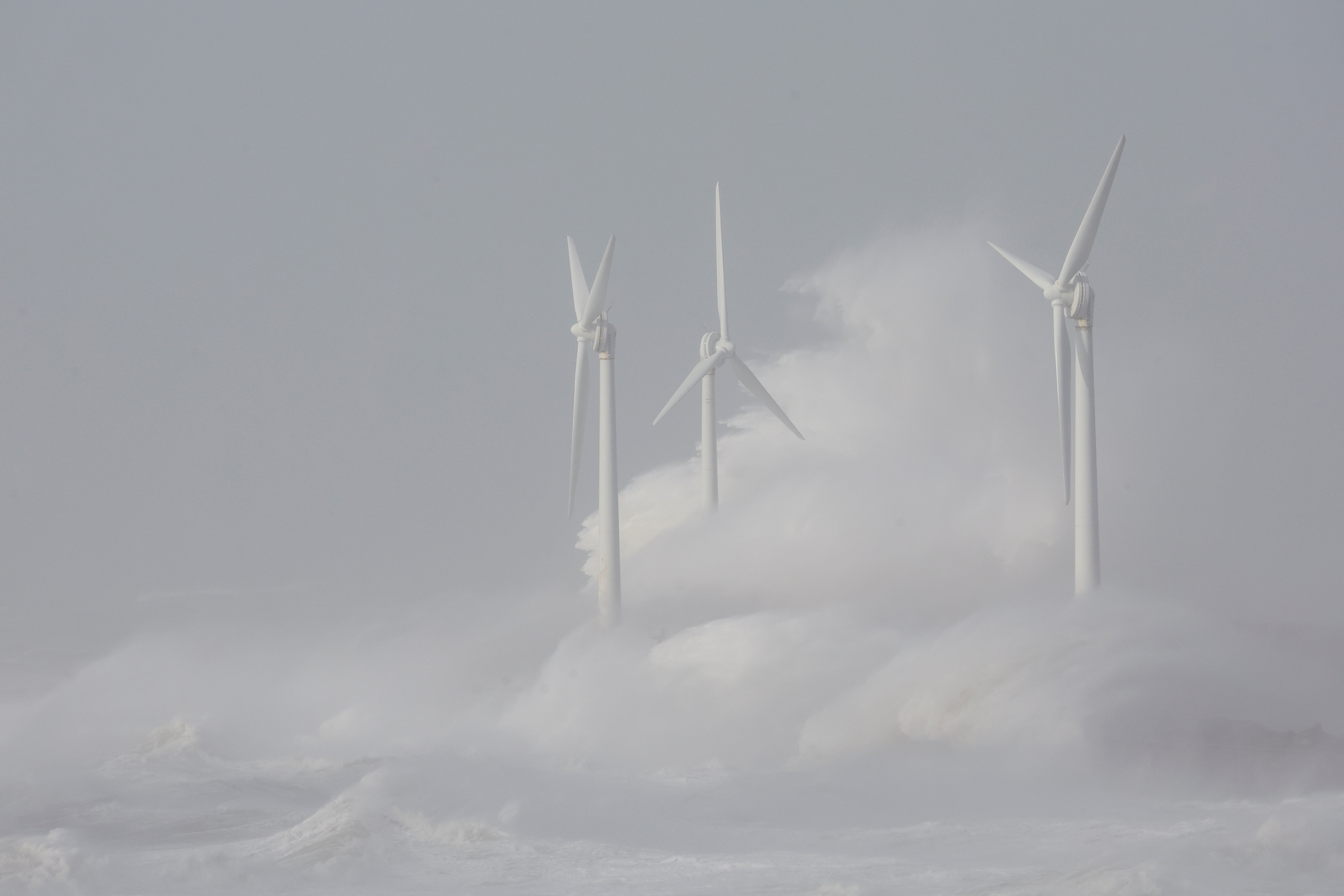 Waves crash against wind turbines during Storm Eunice at Boulogne-sur-Mer, France