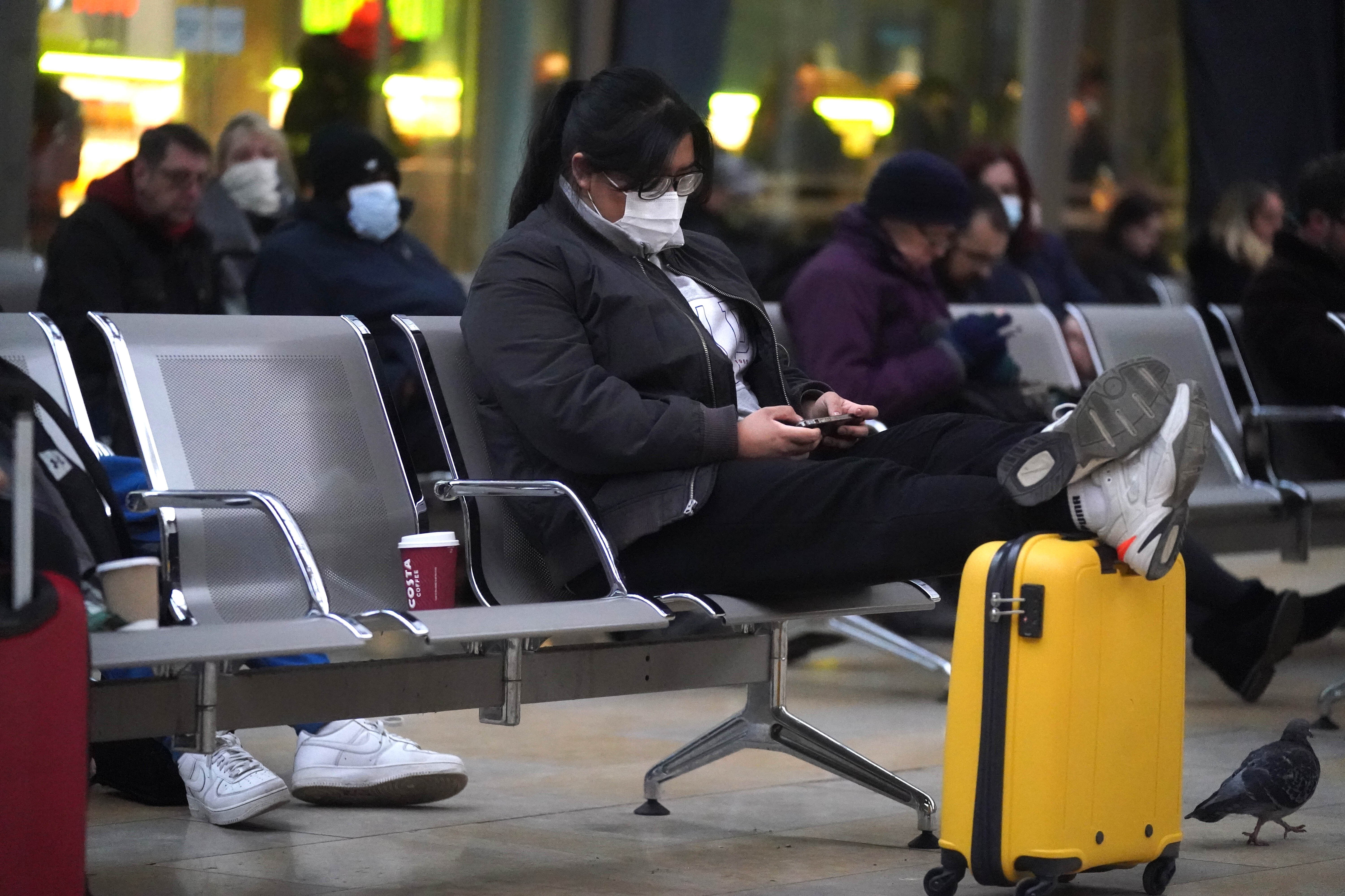 Passengers at Paddington station in London where trains have been cancelled due to Storm Eunice (Victoria Jones/PA)