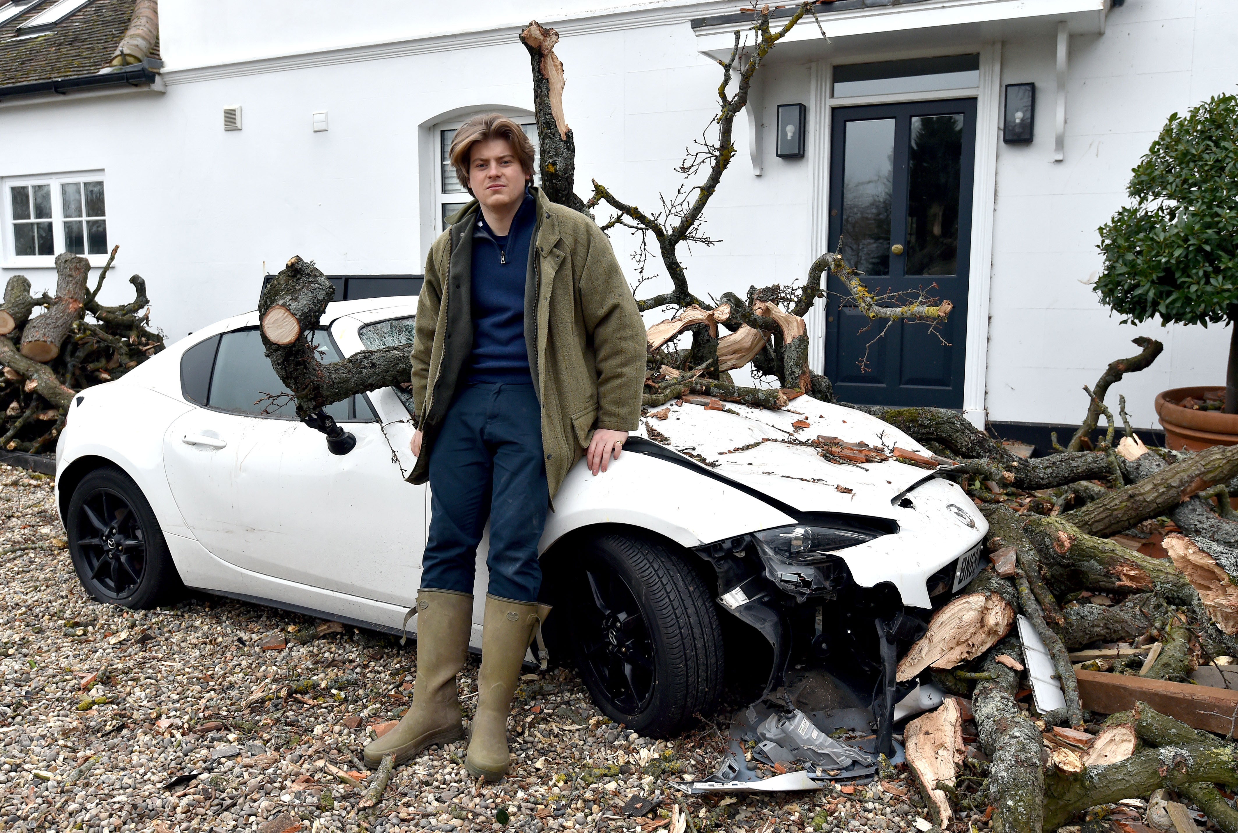 Sven Good and his car that was damaged by falling branches