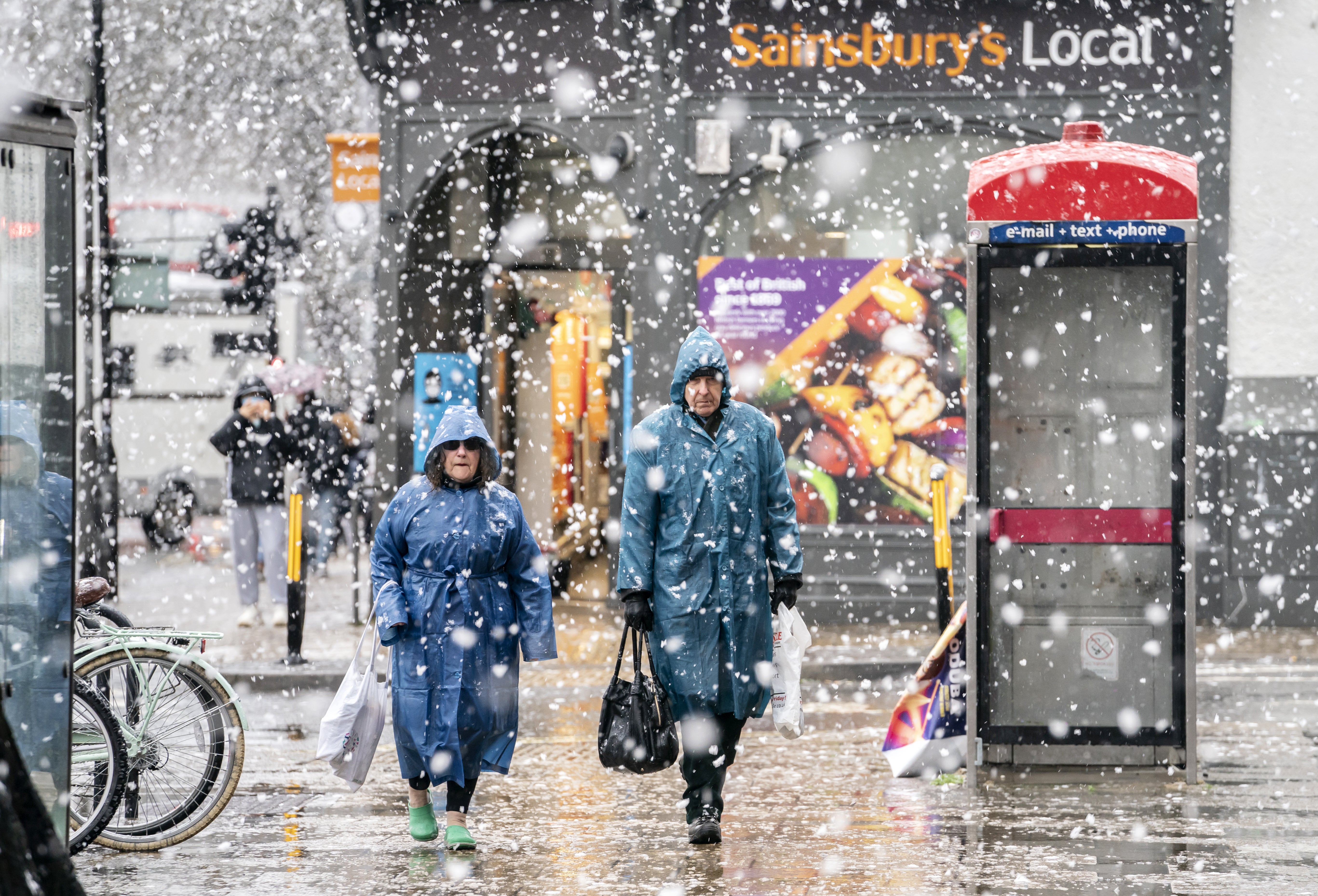 Shoppers in raincoats braving the cold