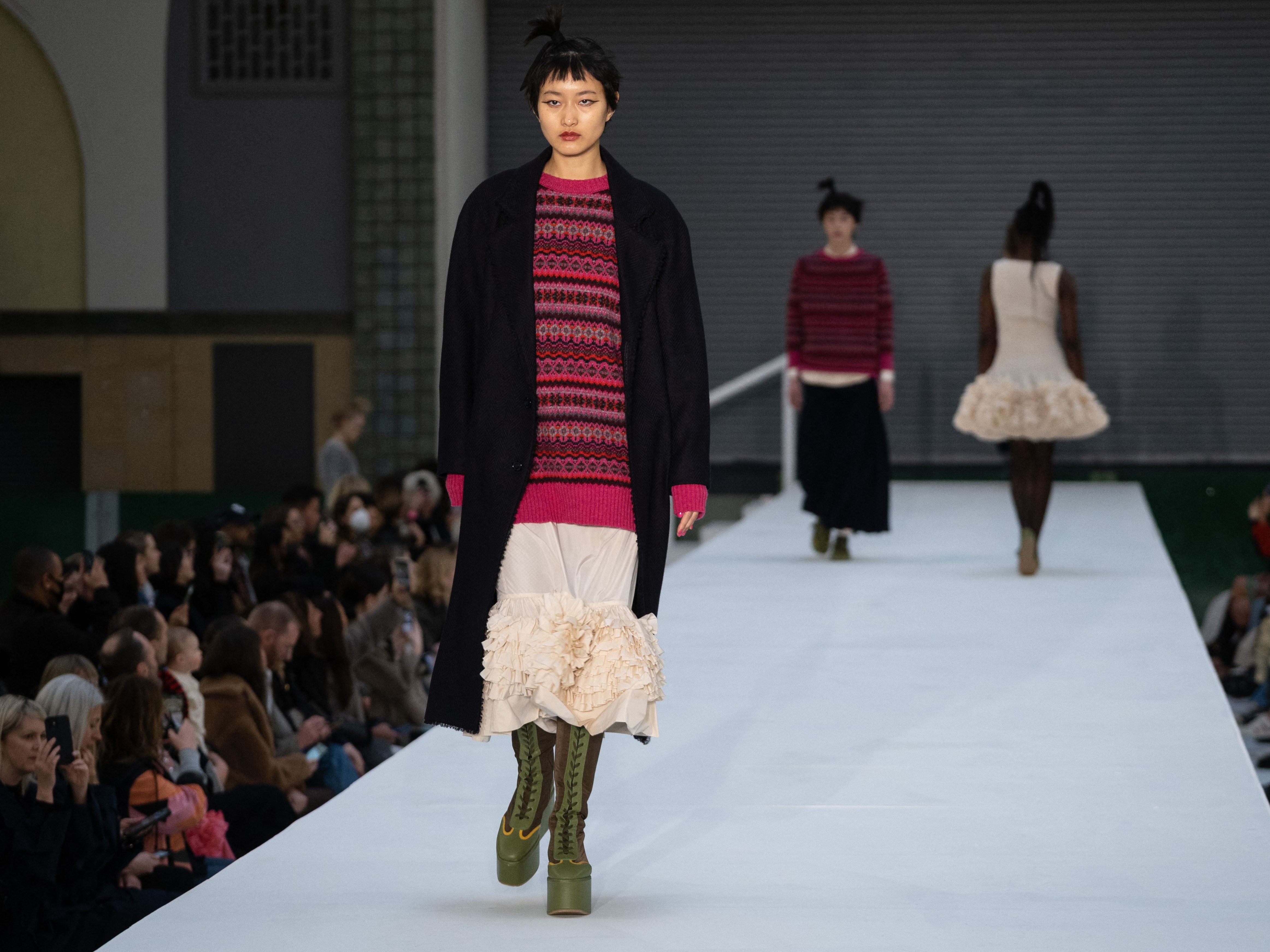 The show featured classic Goddard silhouettes: tutu dresses featuring layers of frills paired with flatform knee-high boots and oversized knee-skimming knits.