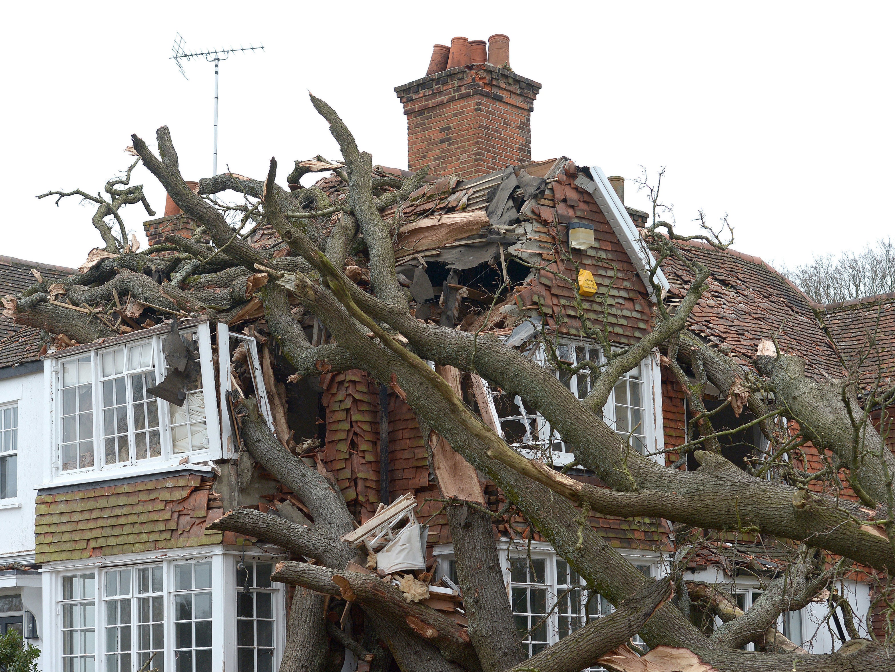 Damaged caused to a home in Stondon Massey, near Brentwood, Essex, after a 400-year-old oak tree was uprooted by Storm Eunice