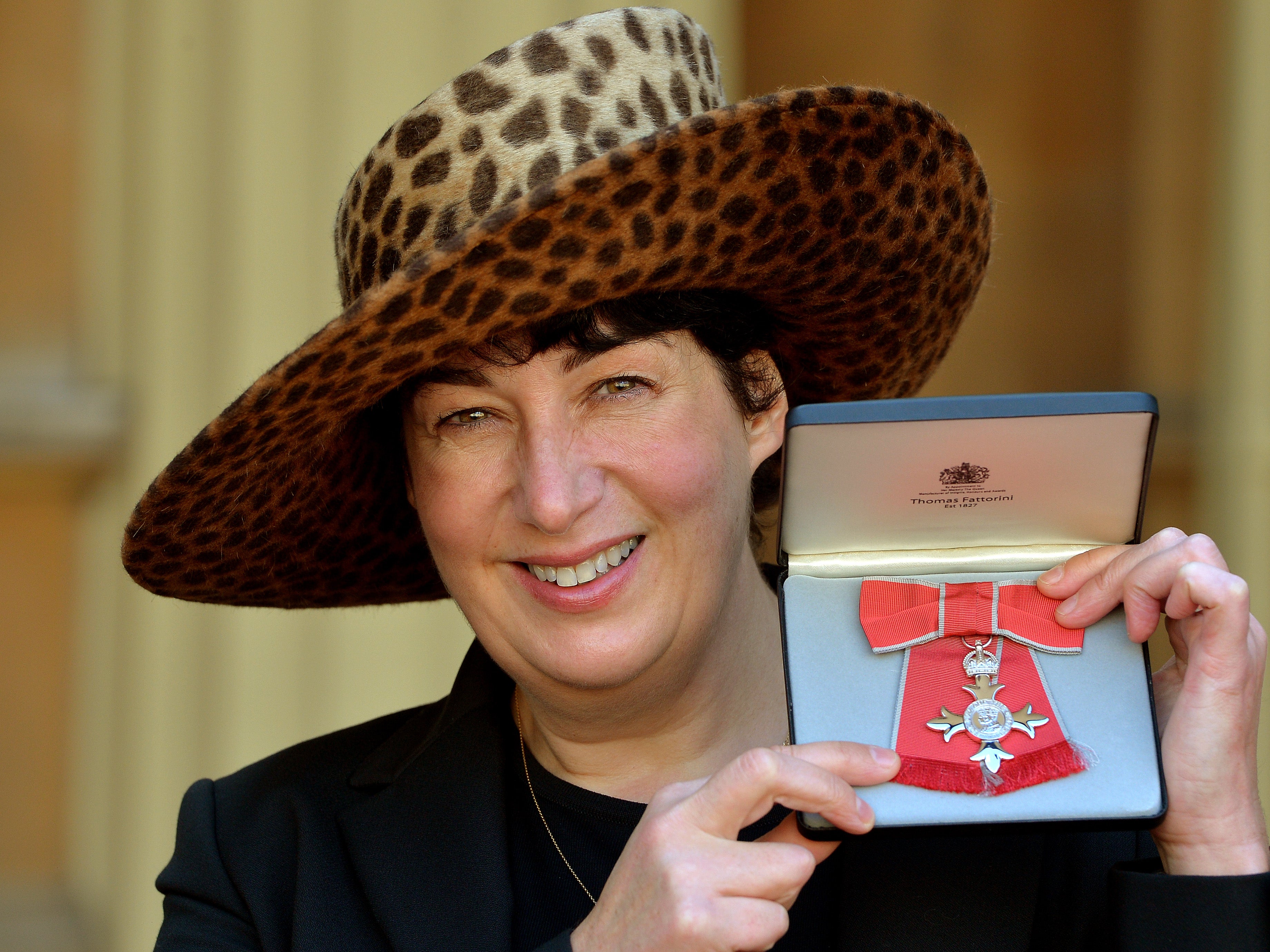 Joanne Harris holding her MBE for services to Literature