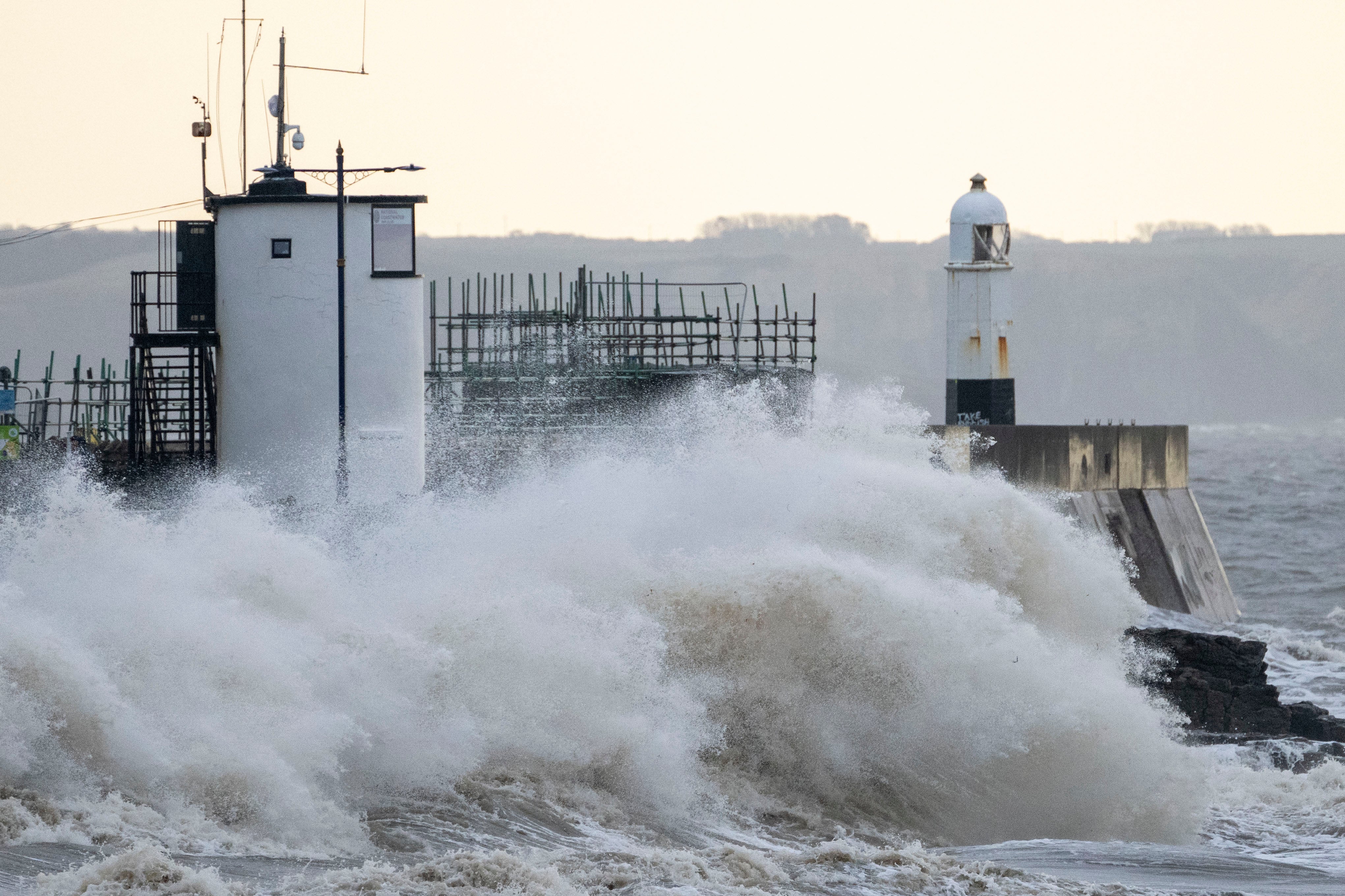 Waves crash against the harbour wall in Porthcawl, Wales