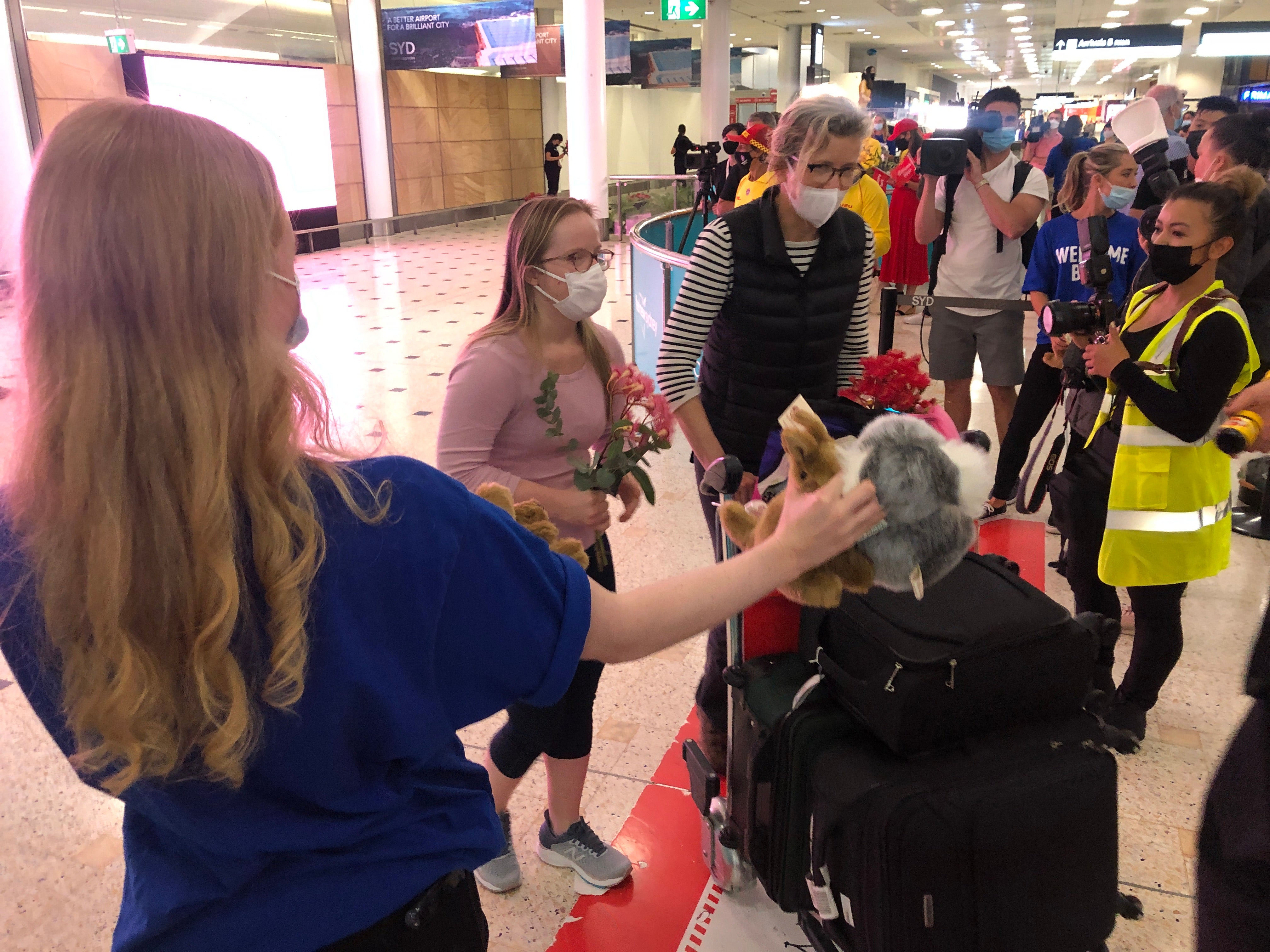 Welcome back: the first passengers to arrive in Sydney after the travel ban lifted were showered with local gifts