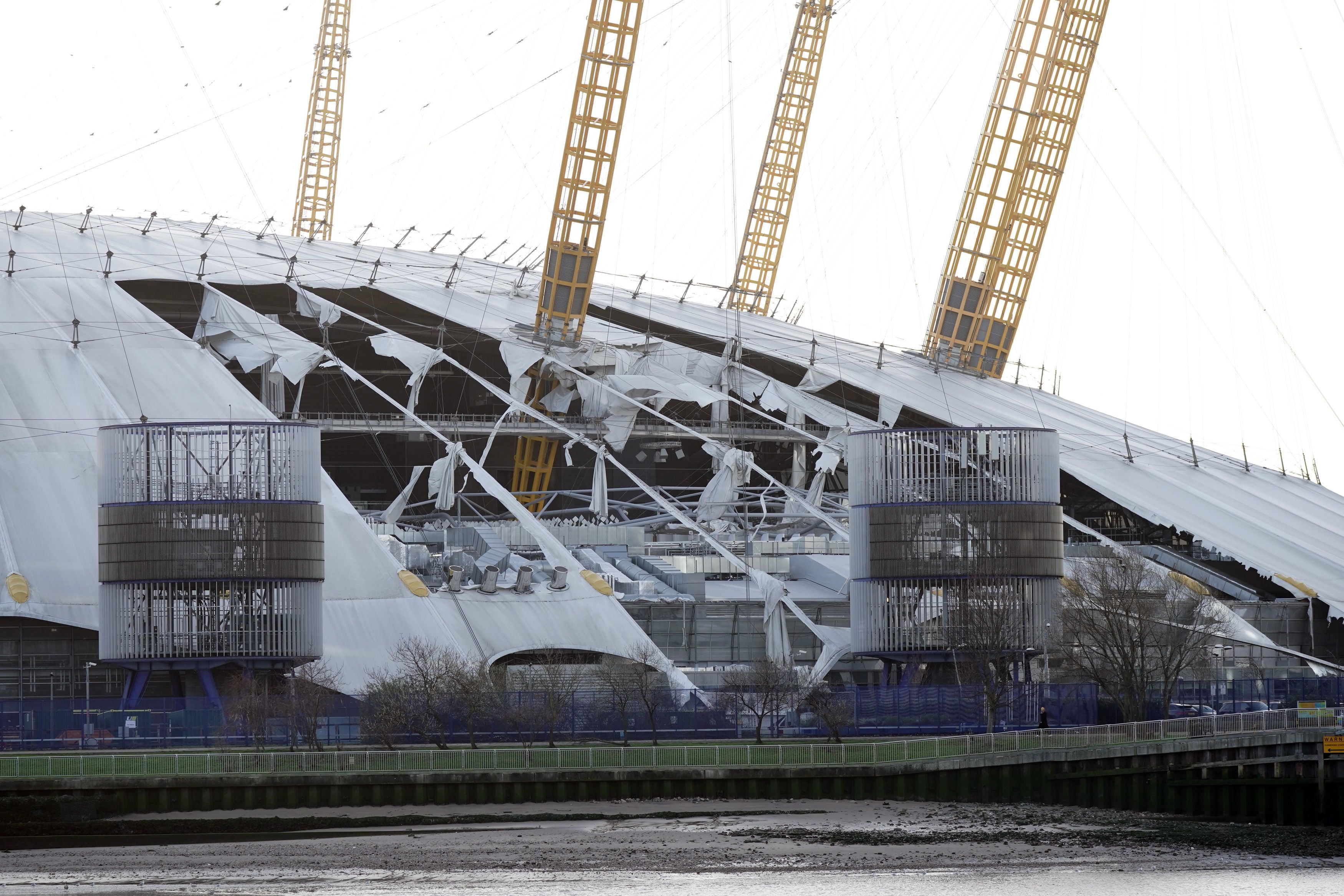 Damage to the white roof covering at the O2 arena in London, which will remain closed until Friday after parts of it were torn away from supporting ribs by high winds during the storm Eunice on Friday.