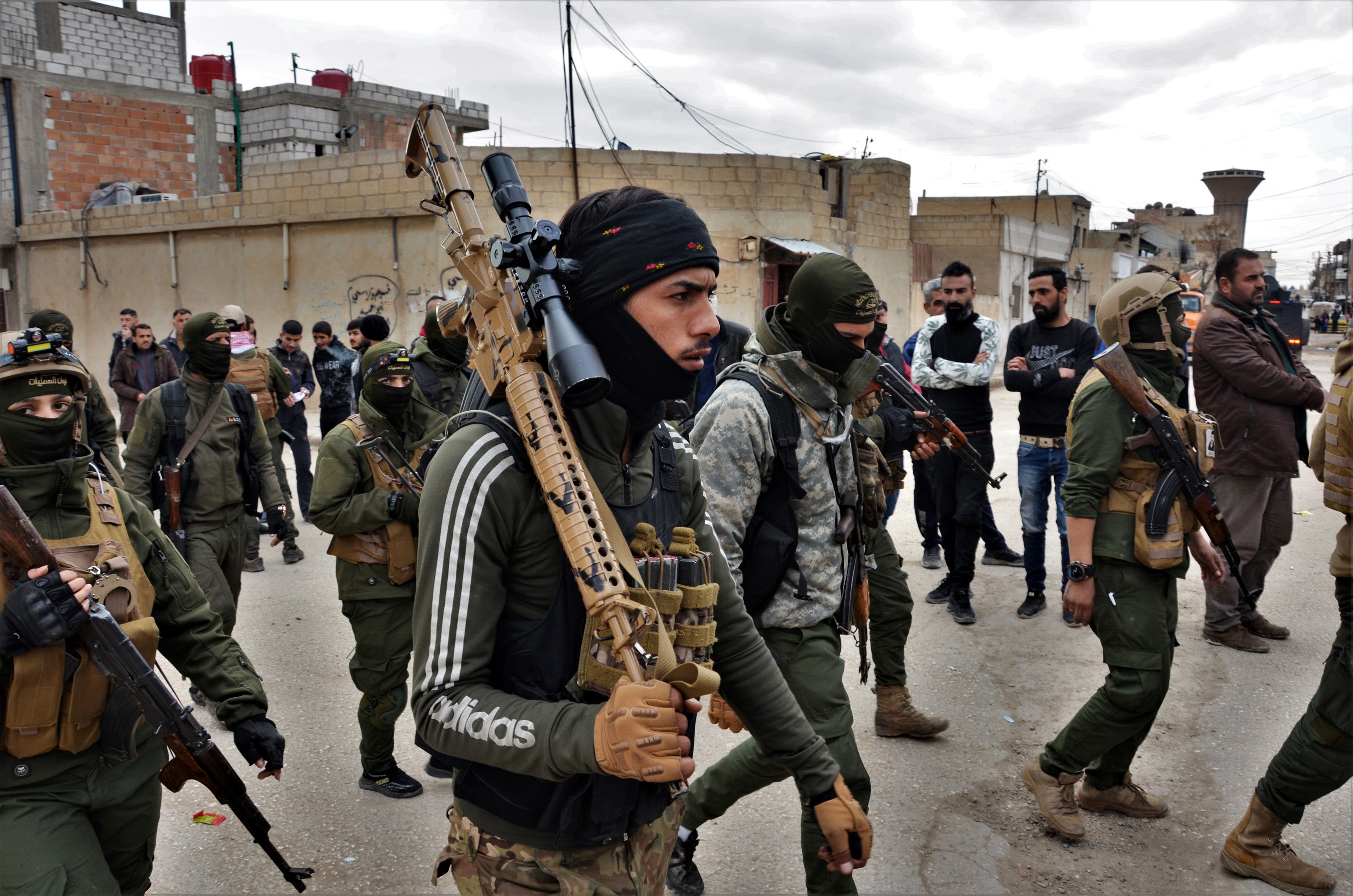 Fighters of the Syria Democratic Forces take part in mop-up operations after a jailbreak attempt by Isis in Hasaka, northeastern Syria