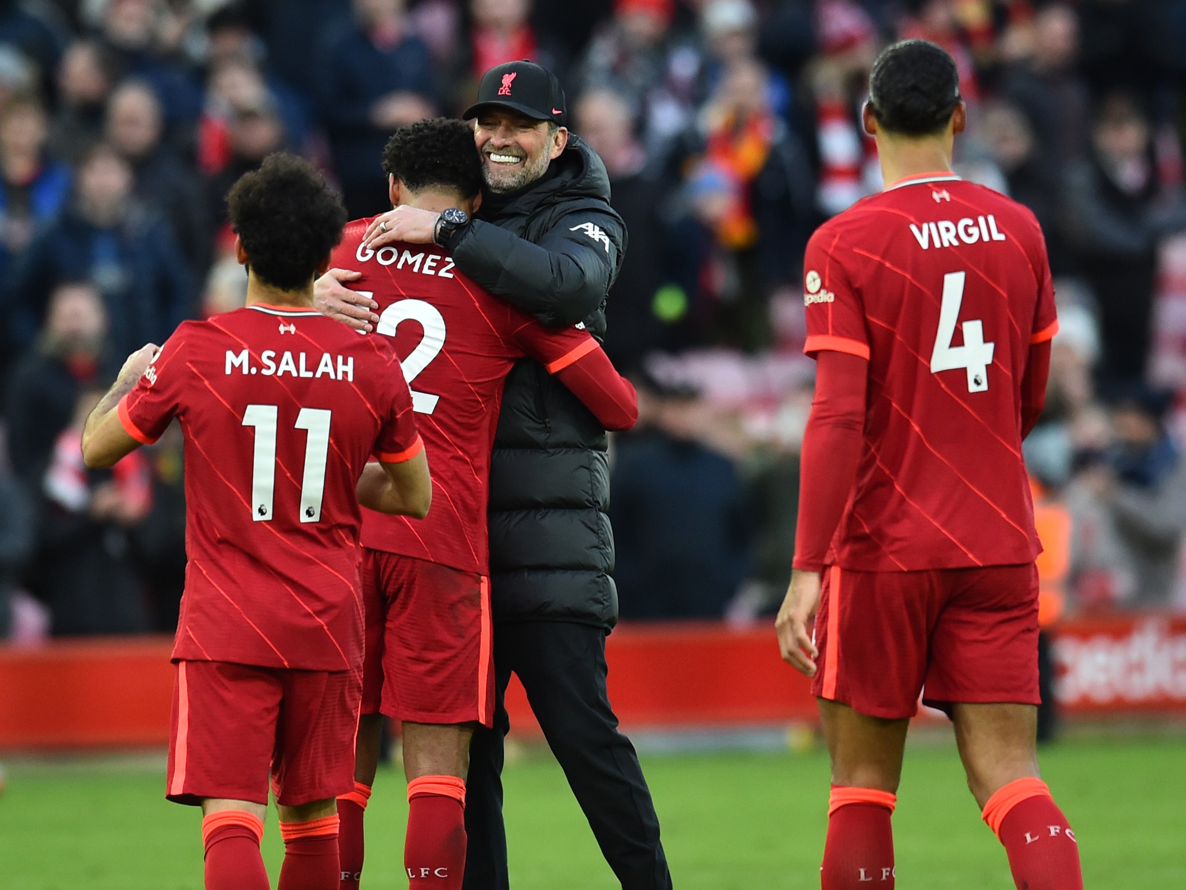 Klopp embraces his players after the Norwich win