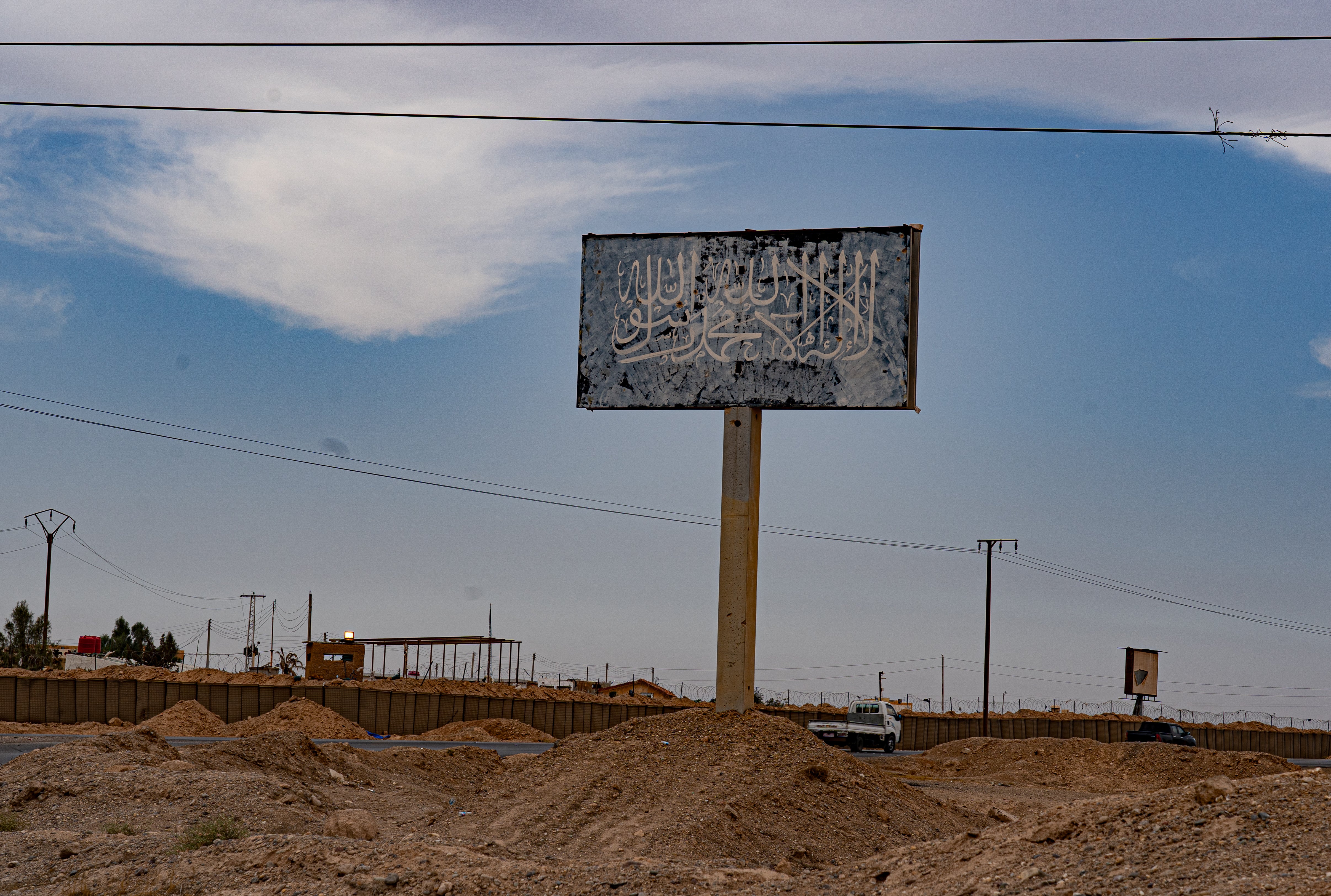 Isis’ partially-obliterated flag on a billboard near the al-Omar oil field