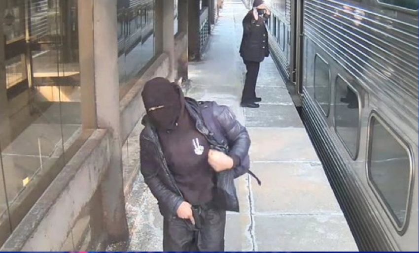 Surveillance footage from Chicago’s Van Buren Street station shows the suspect carrying a gun while the conductor has his hands in the air