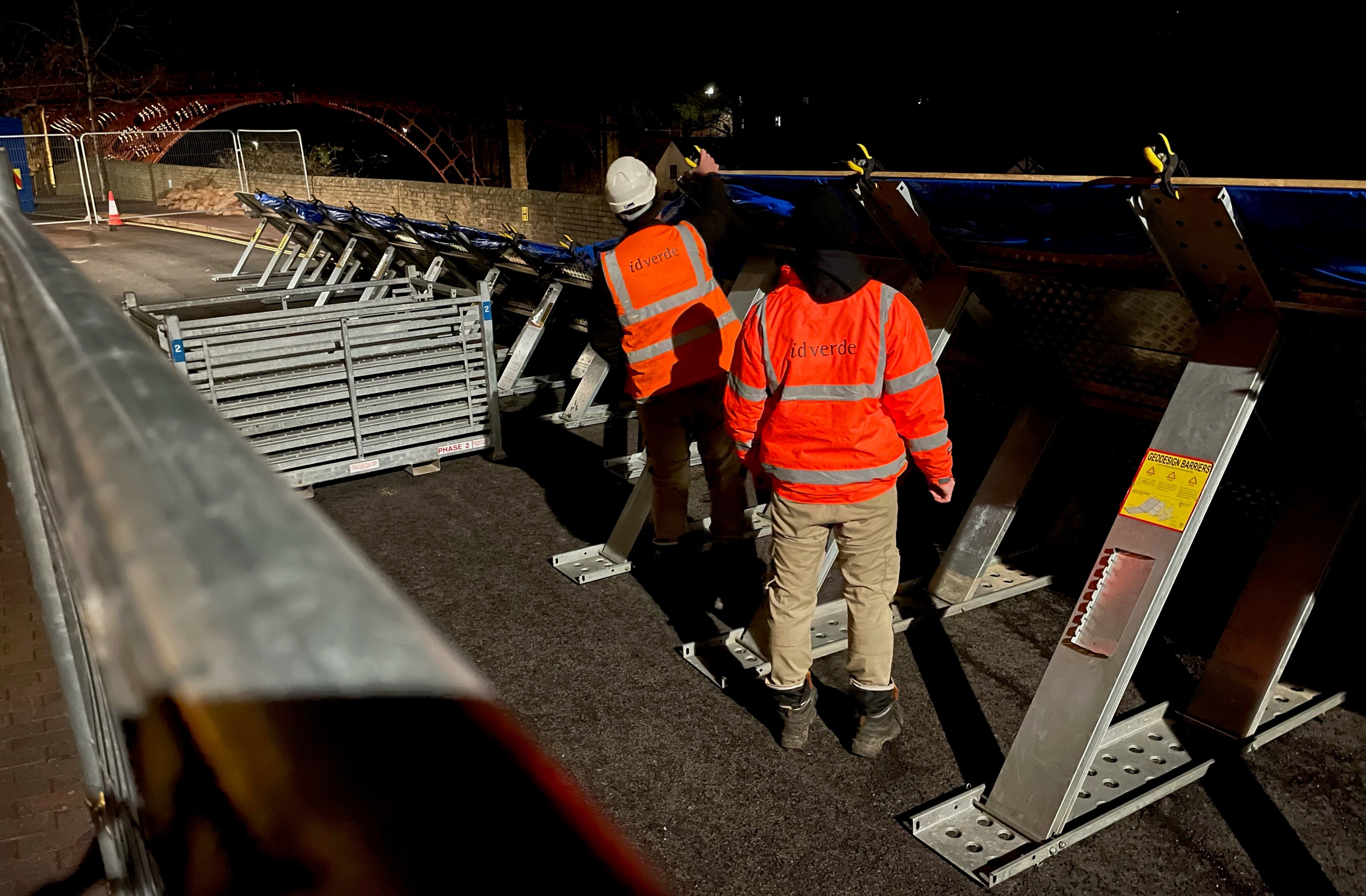 Workmen build flood defences at the River Severn in Ironbridge