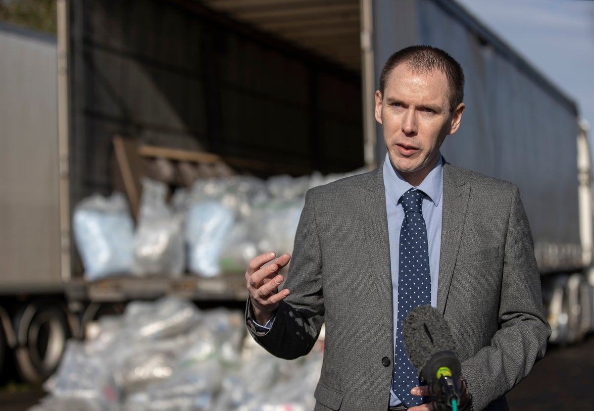 Detective Inspector Conor Sweeney speaks to the media in front of drugs seized by police at Belfast Harbour (Liam McBurney/PA)