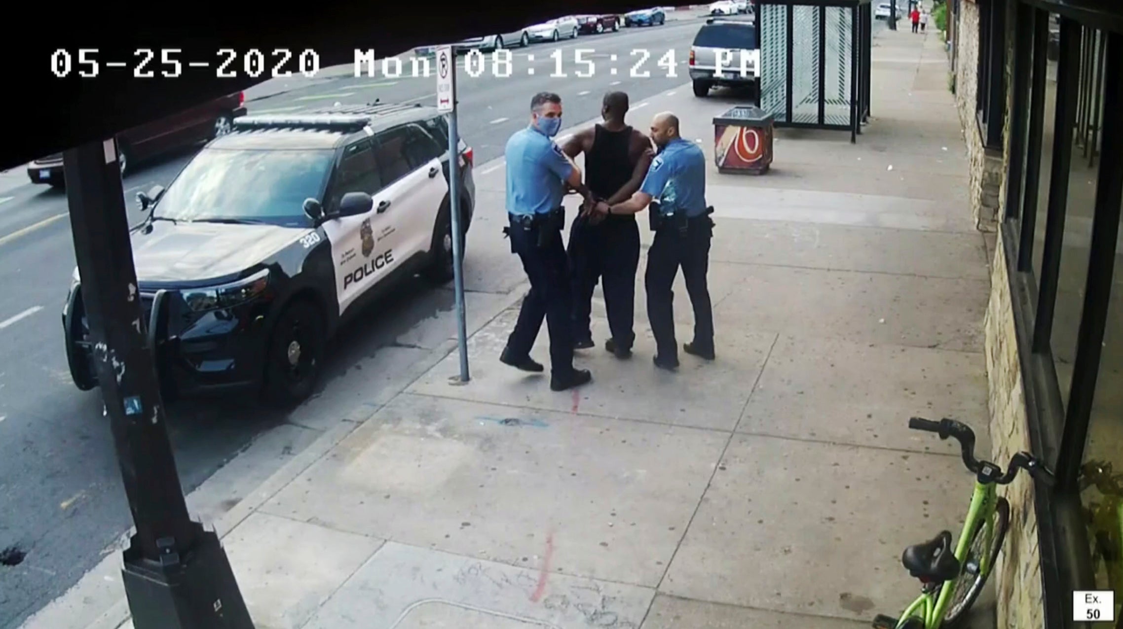 Minneapolis Police Officers Thomas Lane, left and J. Alexander Kueng, right, escorting George Floyd to a police car during his deadly arrest