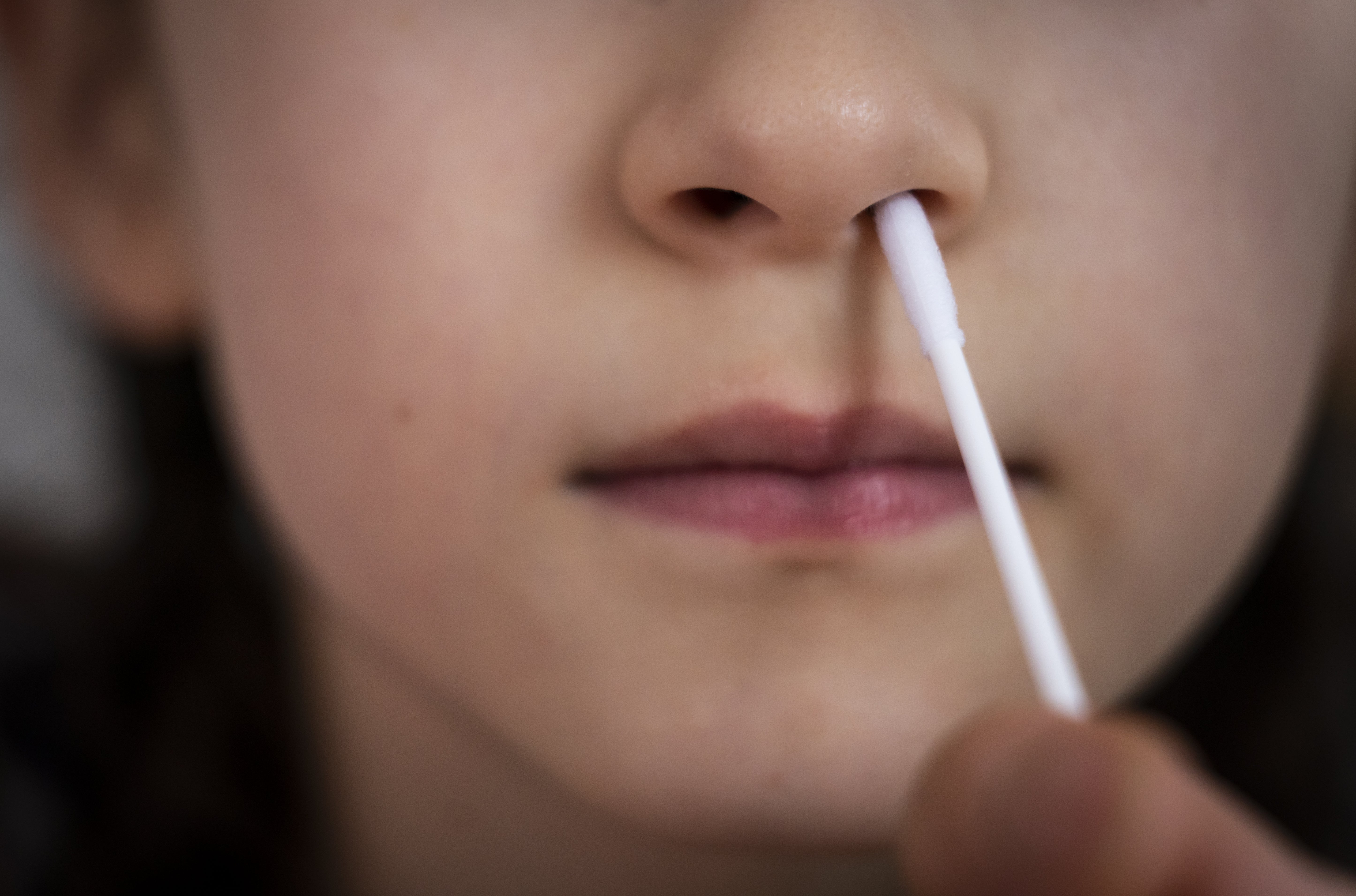 A child takes a Covid-19 lateral flow test (Danny Lawson/PA)