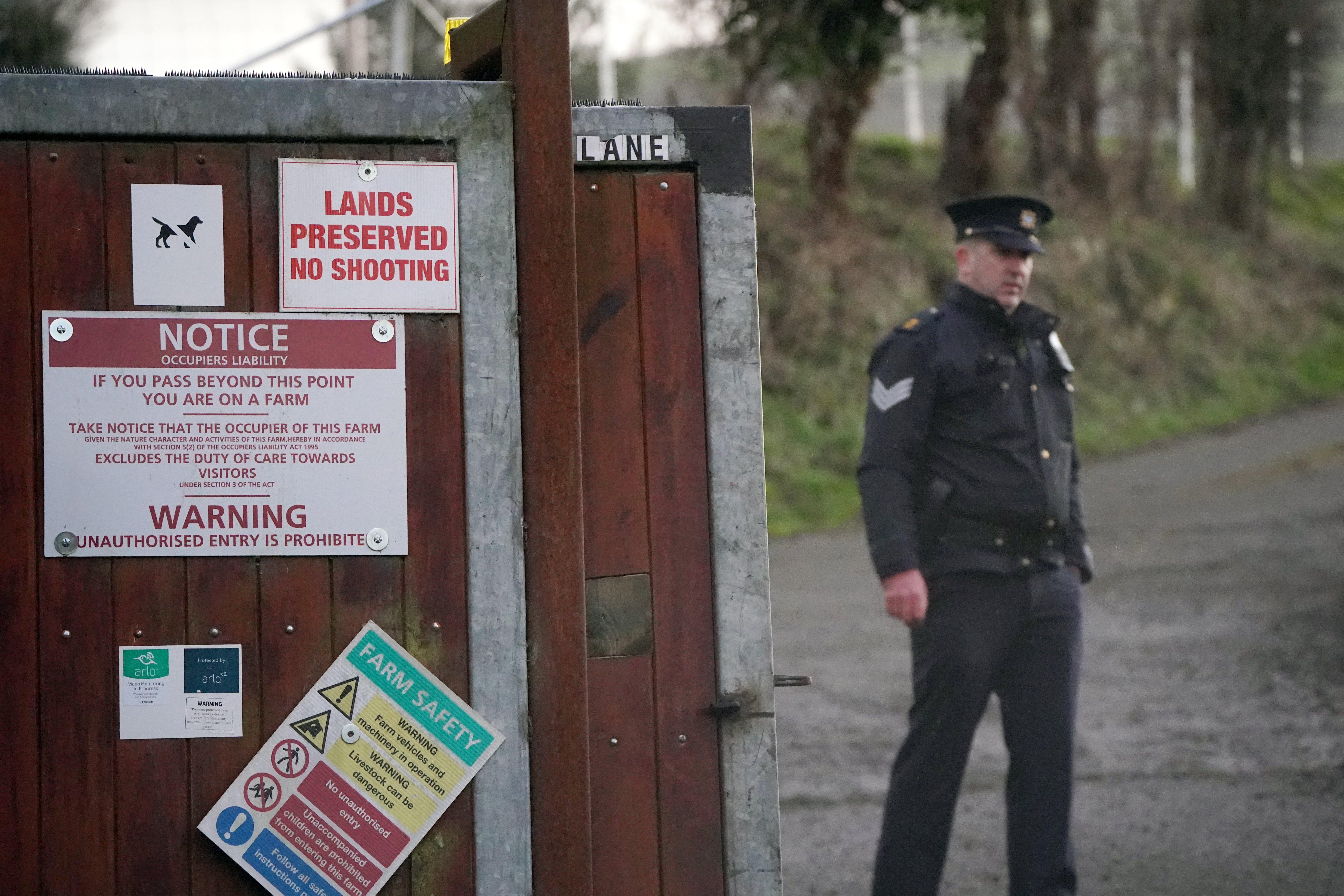 Garda at the scene of a shooting on farmland in Dublin. A man in his 50s is still being detained (Niall Carson/PA)