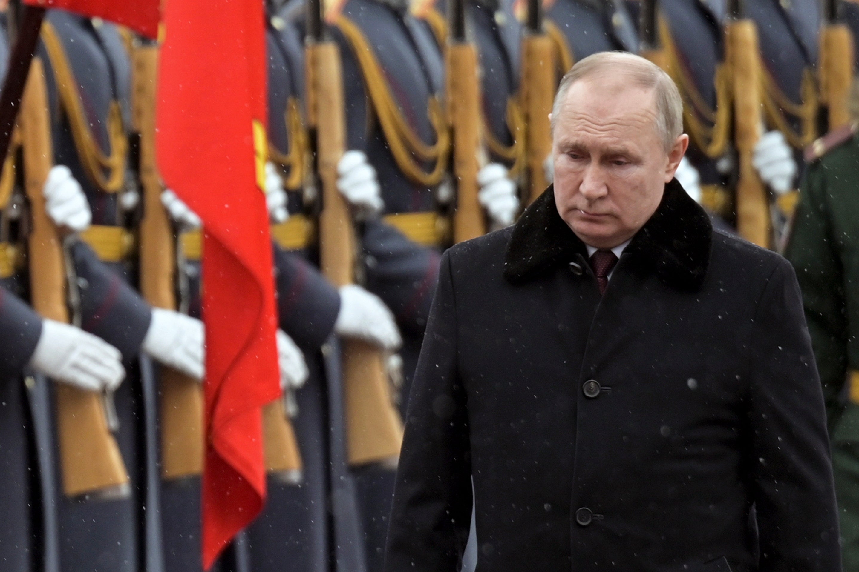 Vladimir Putin attending a military ceremony as the world waits for his move