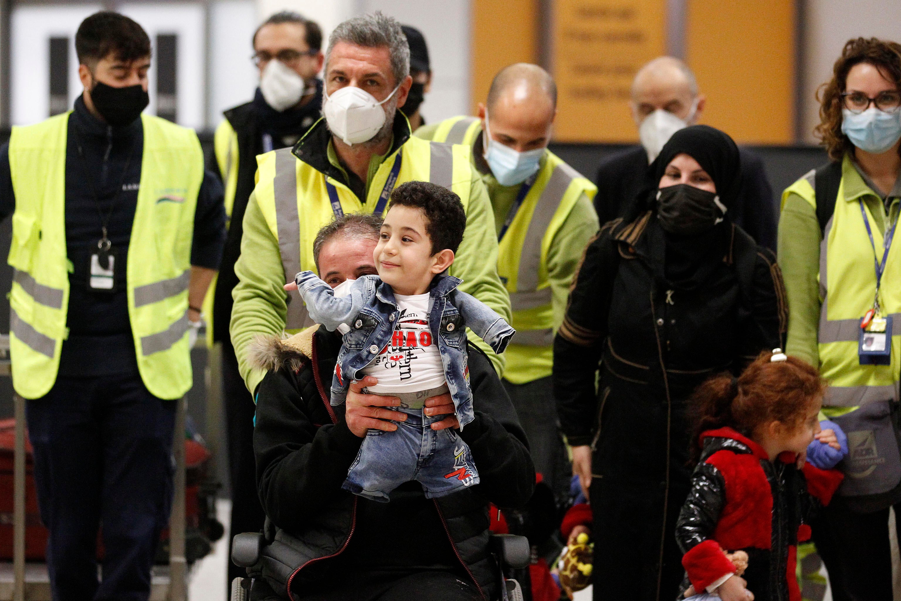 Munzir and son Mustafa arrive with their family at the Leonardo da Vinci international airport in Fiumicino, near Rome, Italy