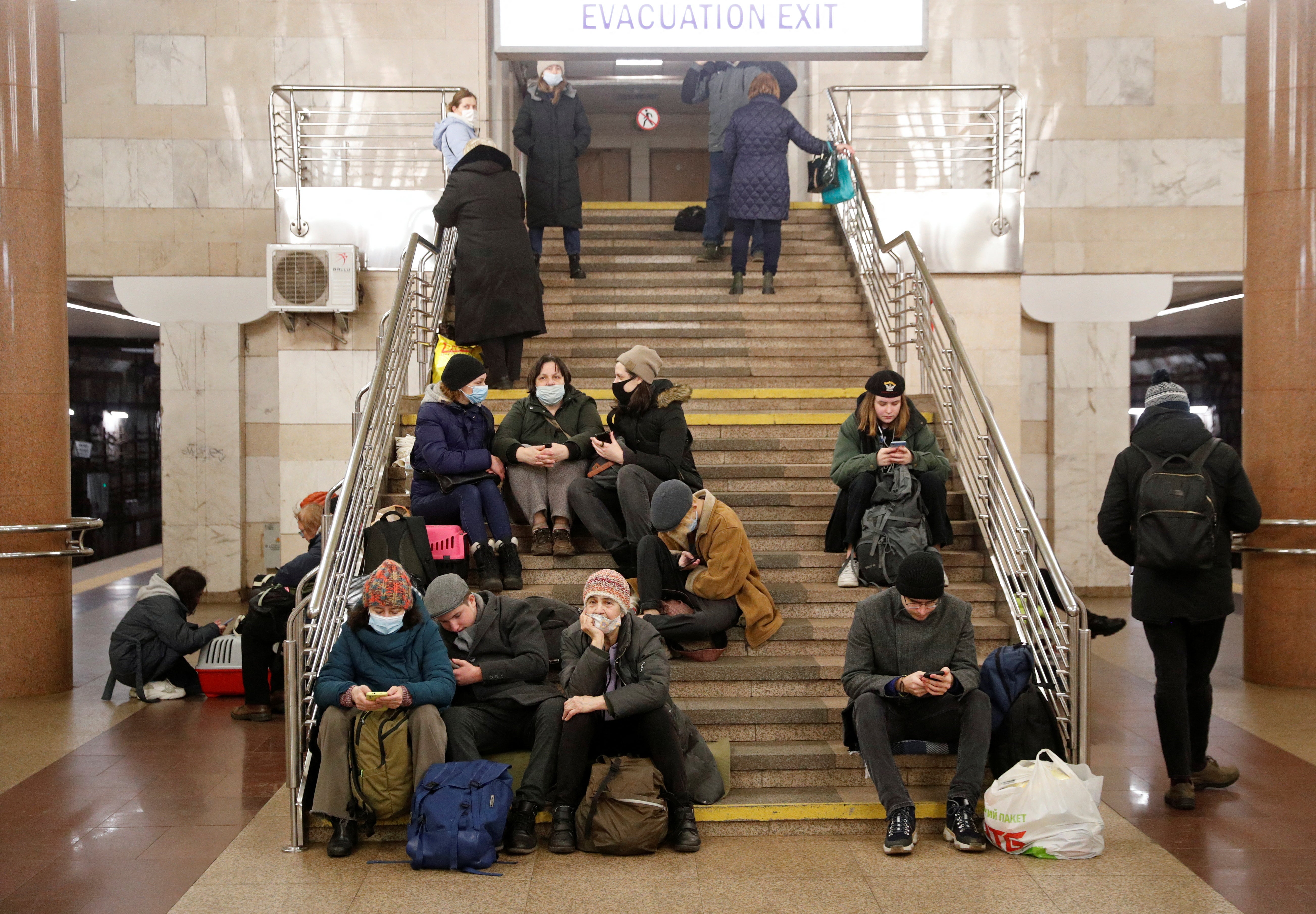 People take shelter in a subway station, after Russian President Vladimir Putin authorised an invasion of Ukraine