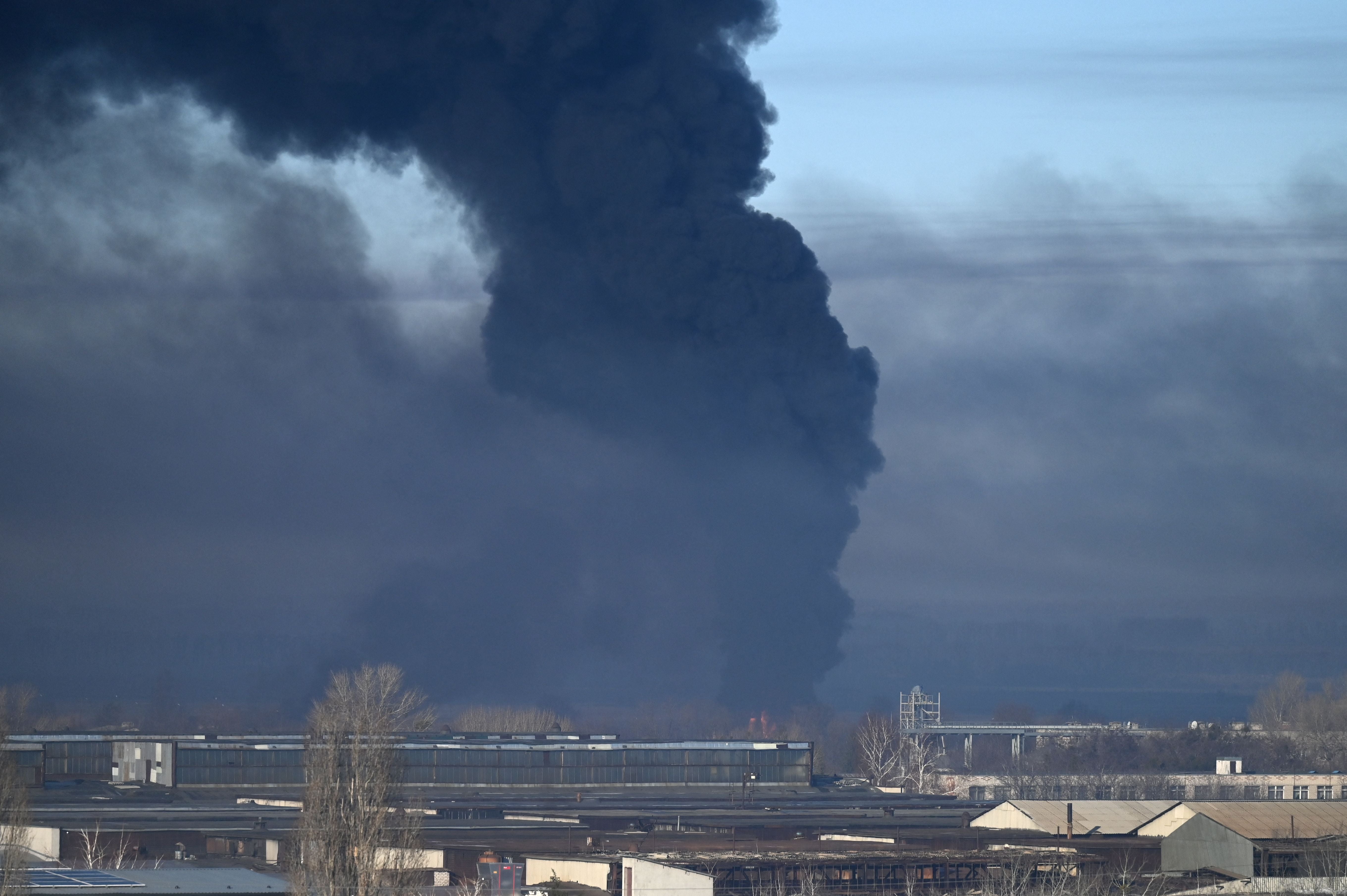 Black smoke rises from a military airport in Chuguyev near Kharkiv on 24 February 2022