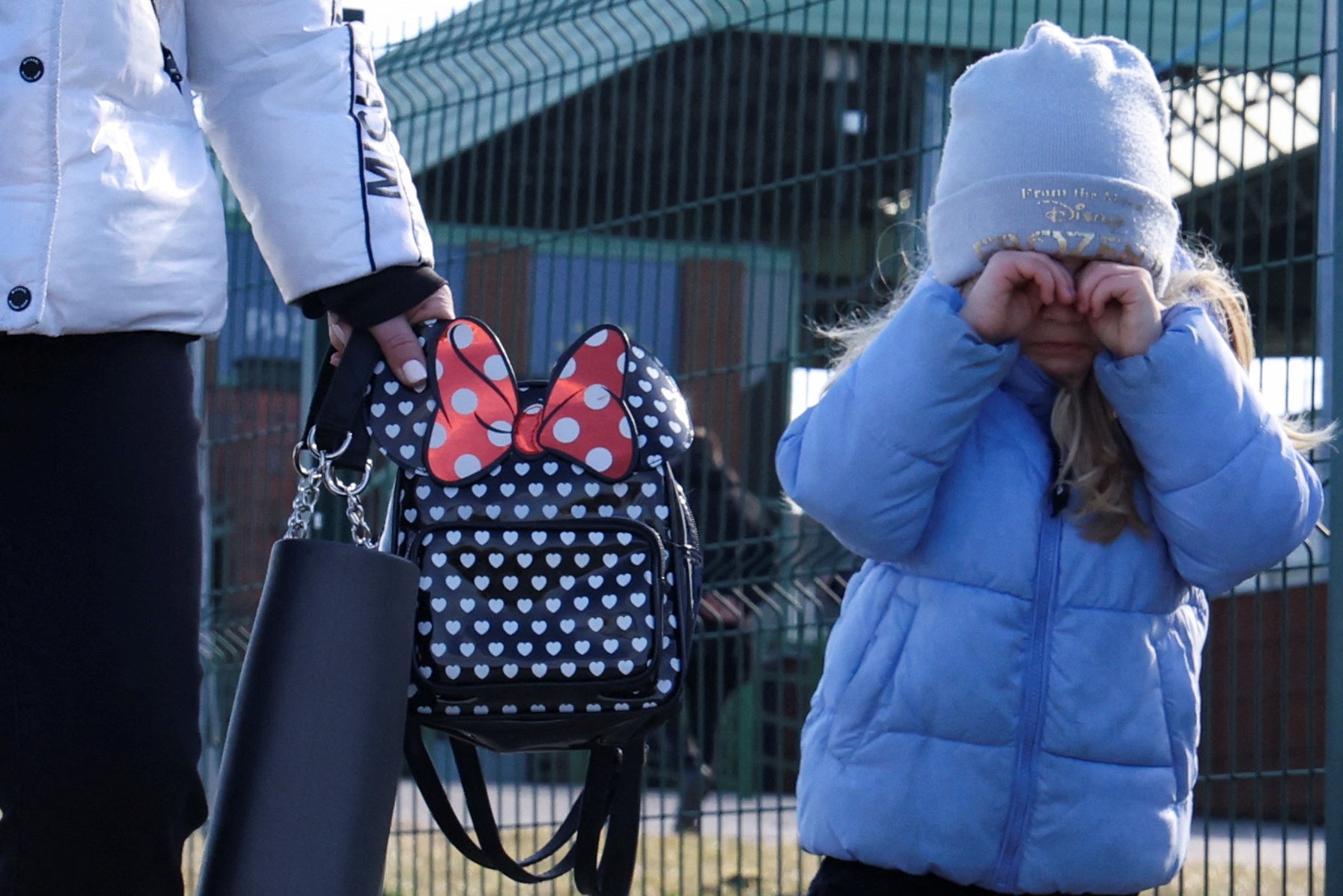 A child stands at the border crossing between Poland and Ukraine, after Russian President Vladimir Putin authorized a military operation in eastern Ukraine