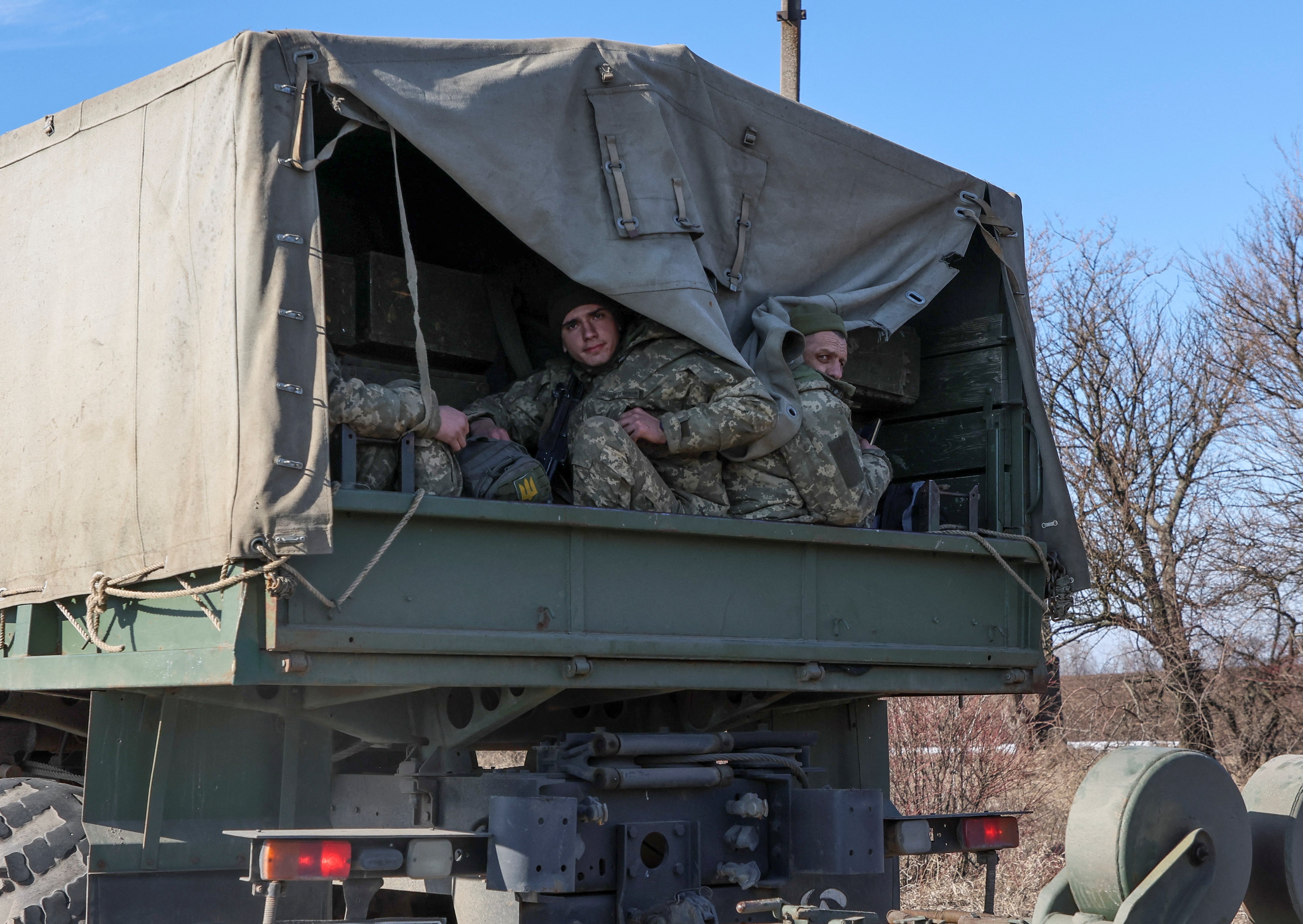 Ukrainian army soldier sits in truck, after Putin authorised military operation, in Kharkiv region